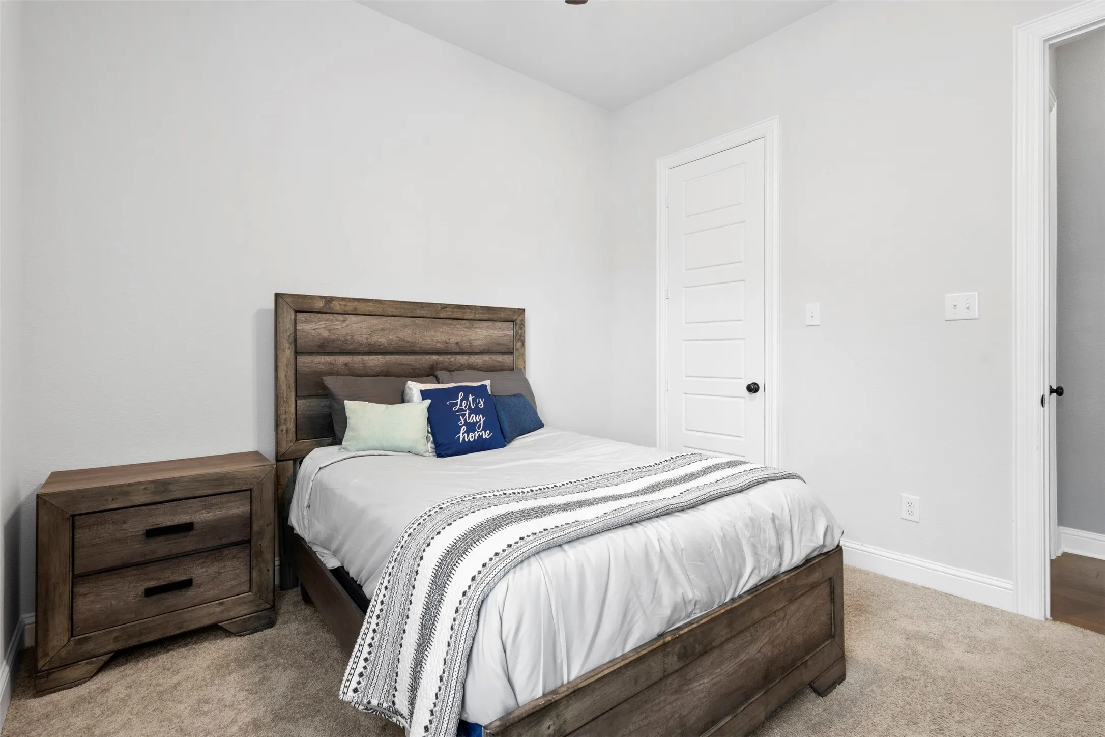 Neutral wall tones complement the plush carpeting