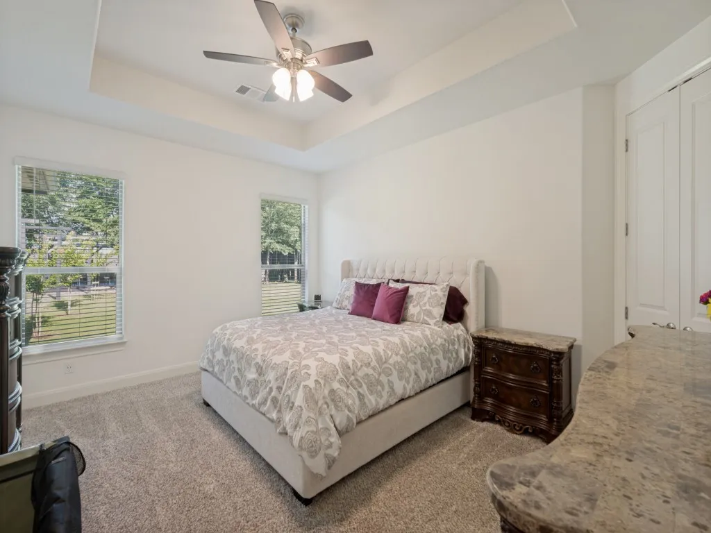 The windows in the primary bedroom let in natural light and offer a spectacular view of the backyard. The room is so spacious with plenty of room for a sitting area, dressers, chest of drawers, night stands, and an in-room television.