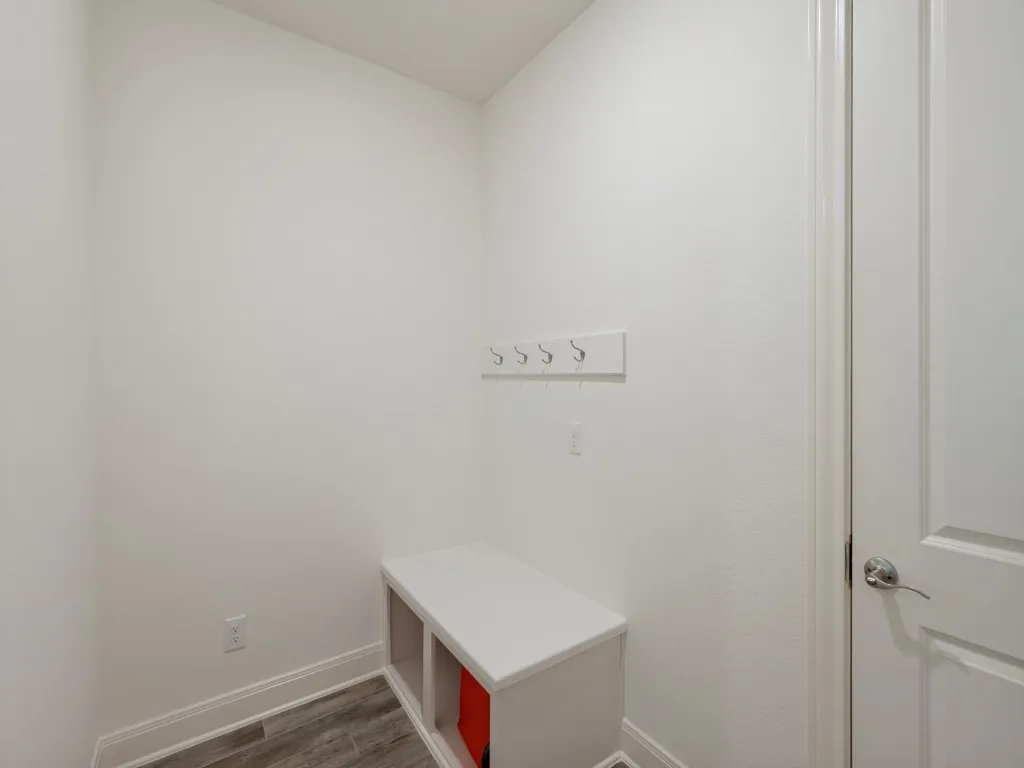 The mudroom between the garage and laundry room is the perfect place to hang coats, purse, keys, jackets, toss the mail, and kick off your shoes to keep all those things organized and off the kitchen counter top!