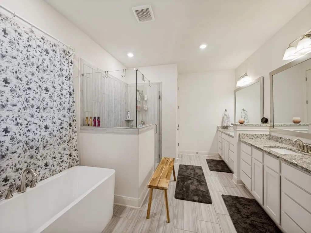 The oversized primary bathroom boasts an abundance of storage with two separate vanities and a linen closet.