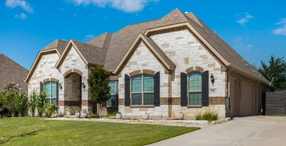 Plenty of parking available with the long driveway and 3-car garage. Beautiful walk up to the front door--notice the custom brick work over the windows. Cedar shutters and coach lights create lovely accents.