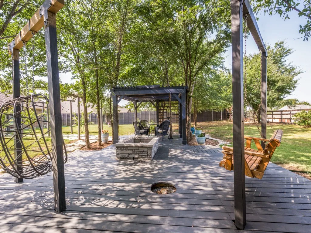 This backyard sanctuary offers multiple ways to relax whether it be reading a book on the swings, gathering around the firepit or enjoying a meal with family and friends. Hanging bench and egg chair stay with the property.