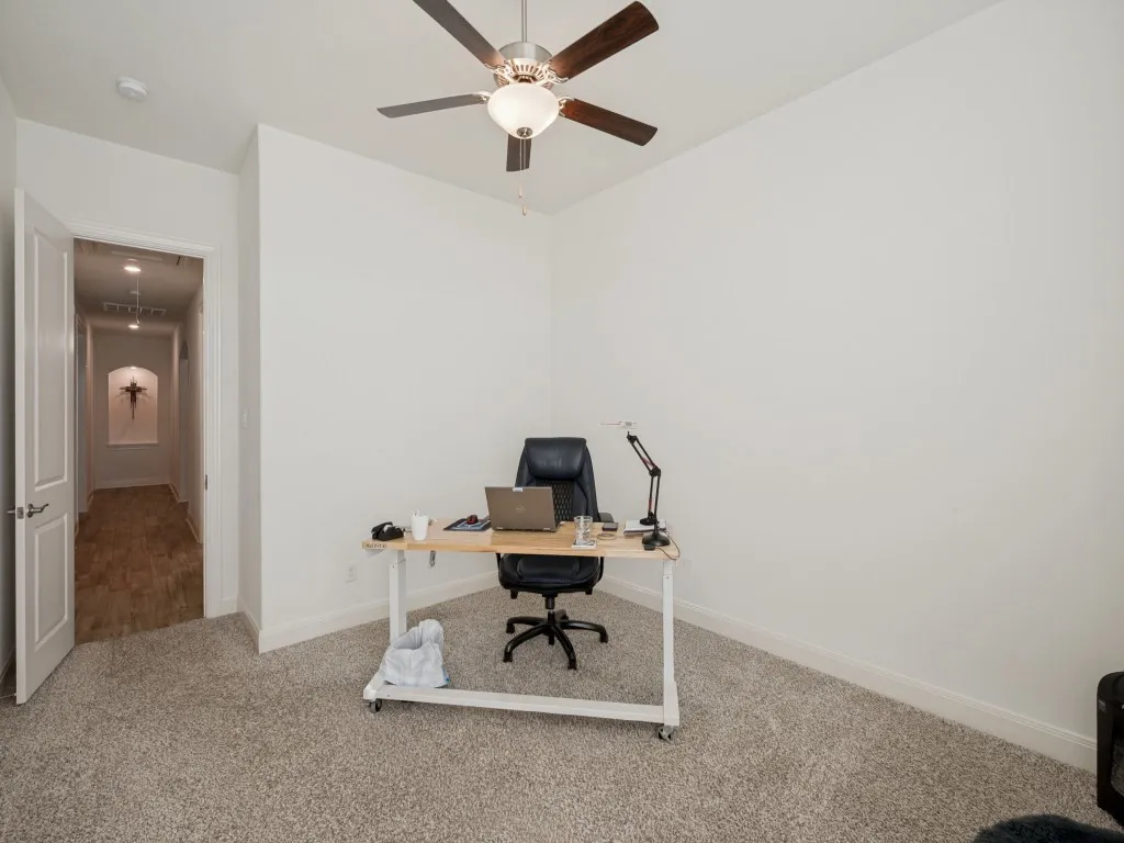 Front bedroom with a large walk-in closet and ceiling fan.  This photo lets you see down the hallway of the guest wing--includes three guest rooms and 2nd living​​‌​​​​‌​​‌‌​‌‌​​​‌‌​‌​‌​‌​​​‌​​ area.