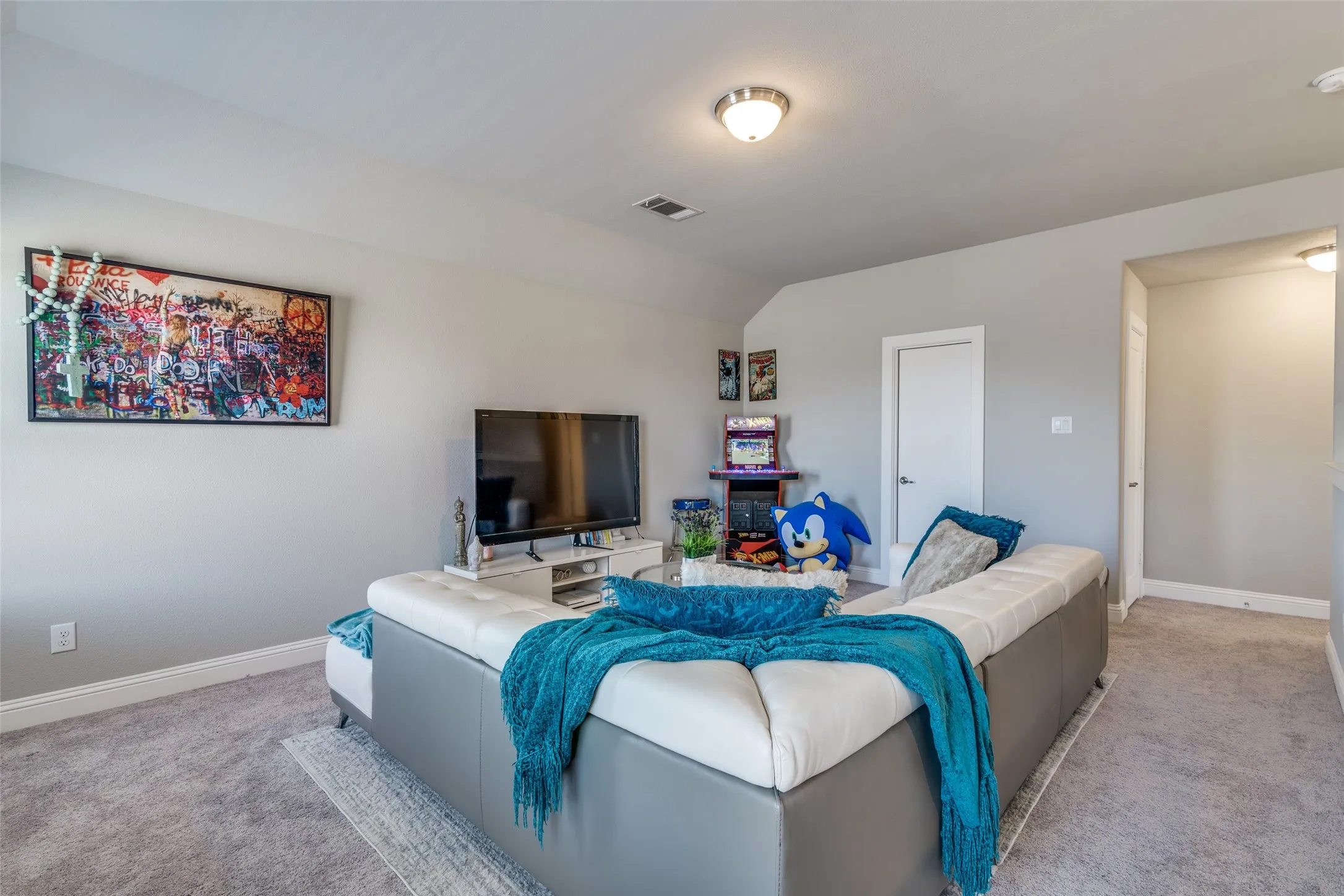 Carpeted bonus room featuring light gray walls, white trim, and a flush mount ceiling light fixture