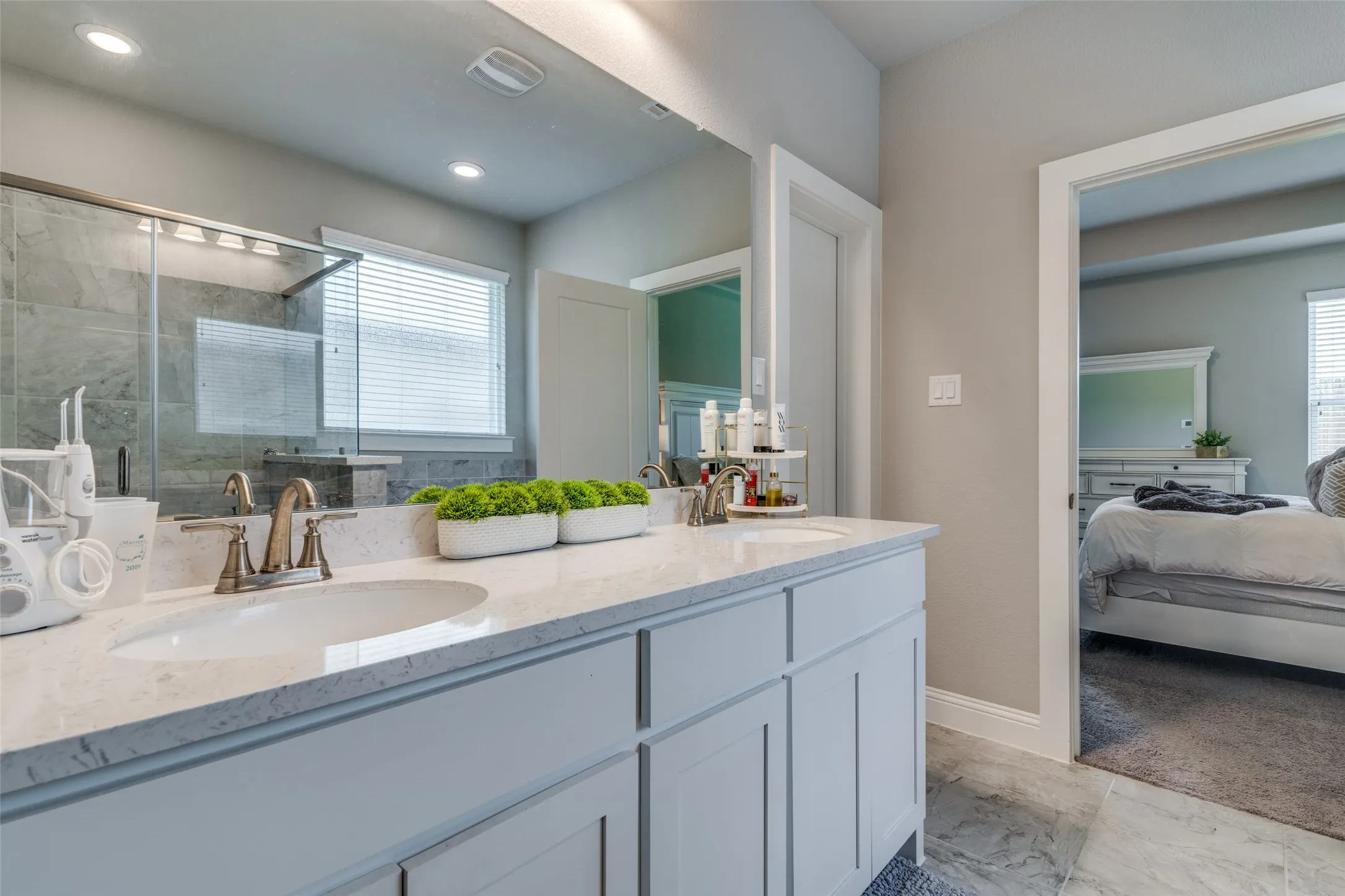 Double vanity with light countertops and undermount sinks