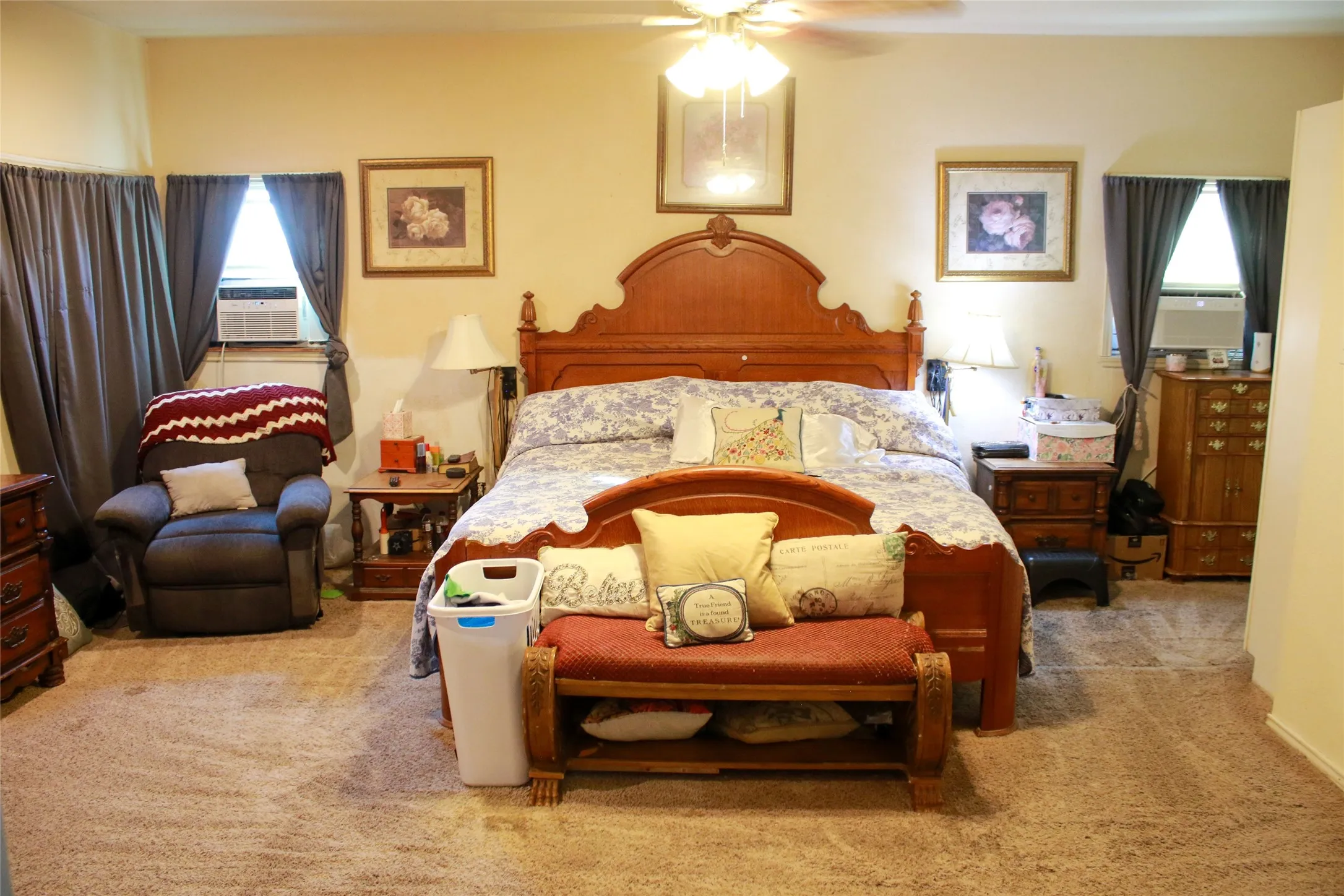 Carpeted flooring, ceiling fan, and window-mounted air conditioning units