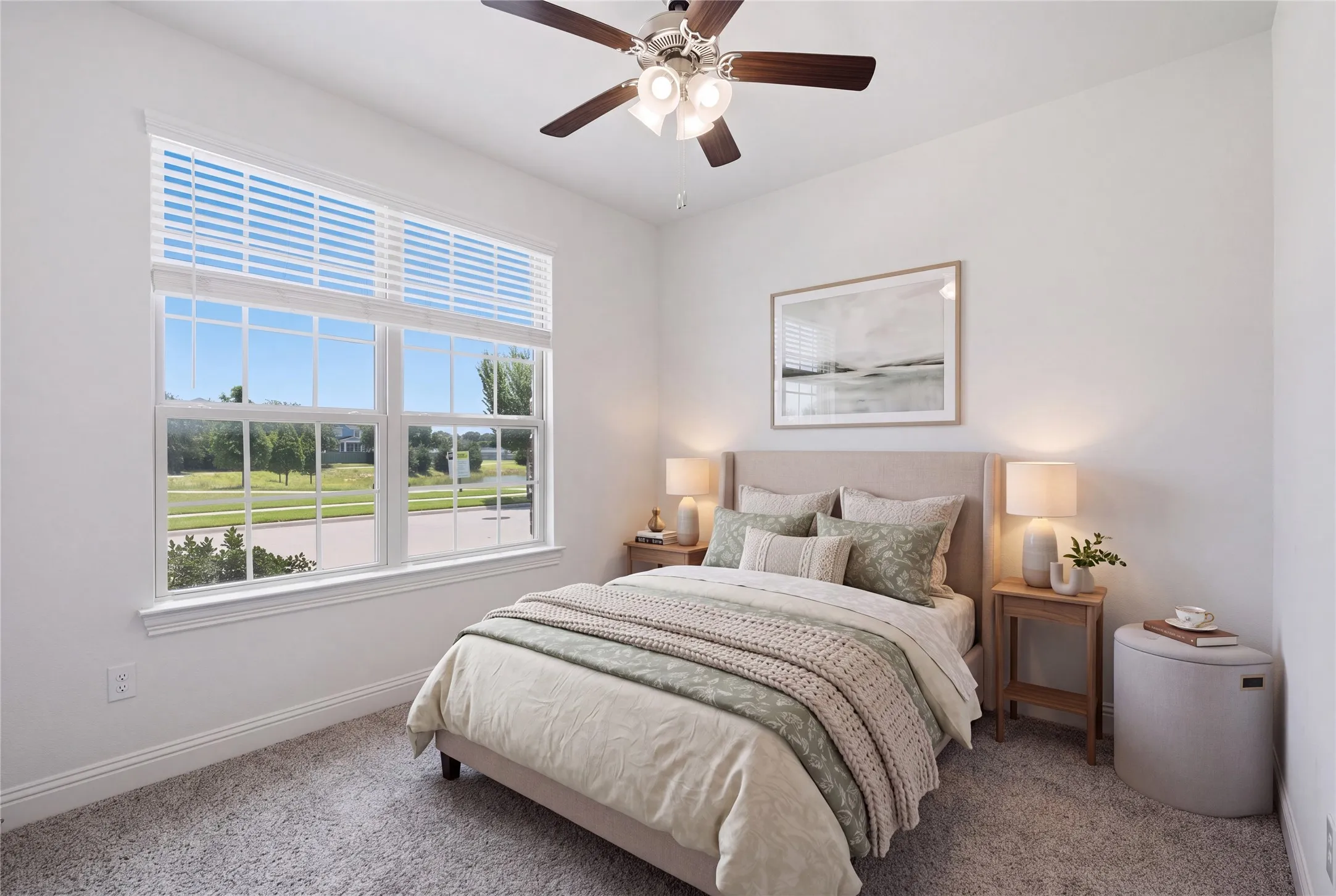 Spacious room with a large window and transom, carpeted flooring, and a ceiling fan with light fixture