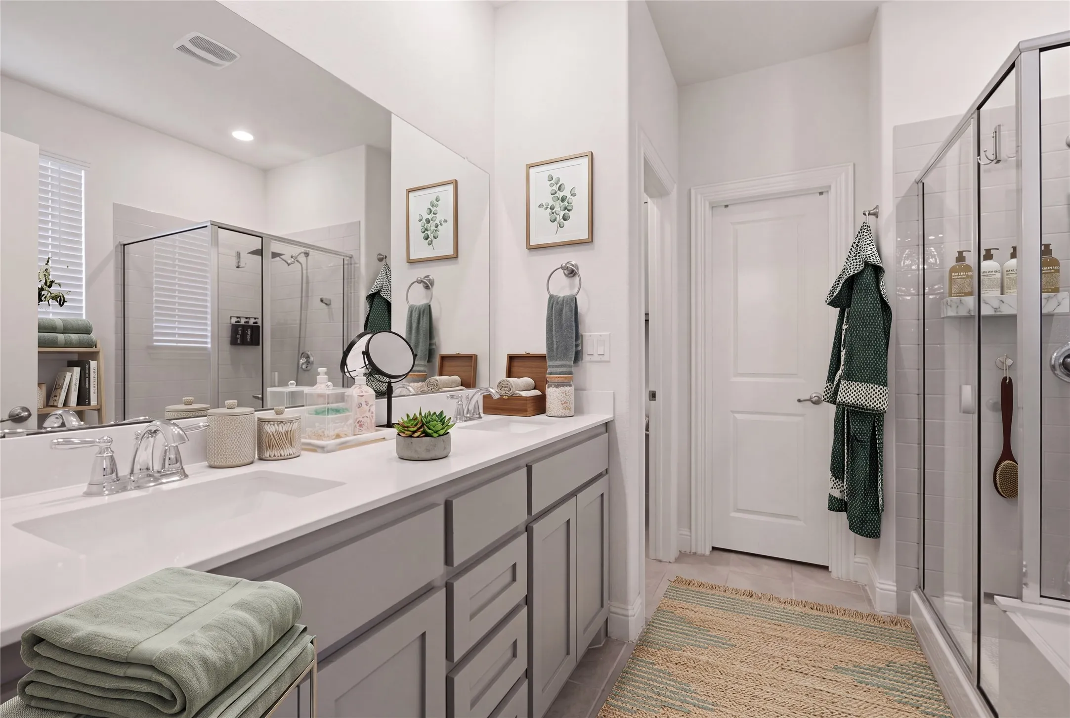 Dual vanity with light gray cabinetry and white countertops