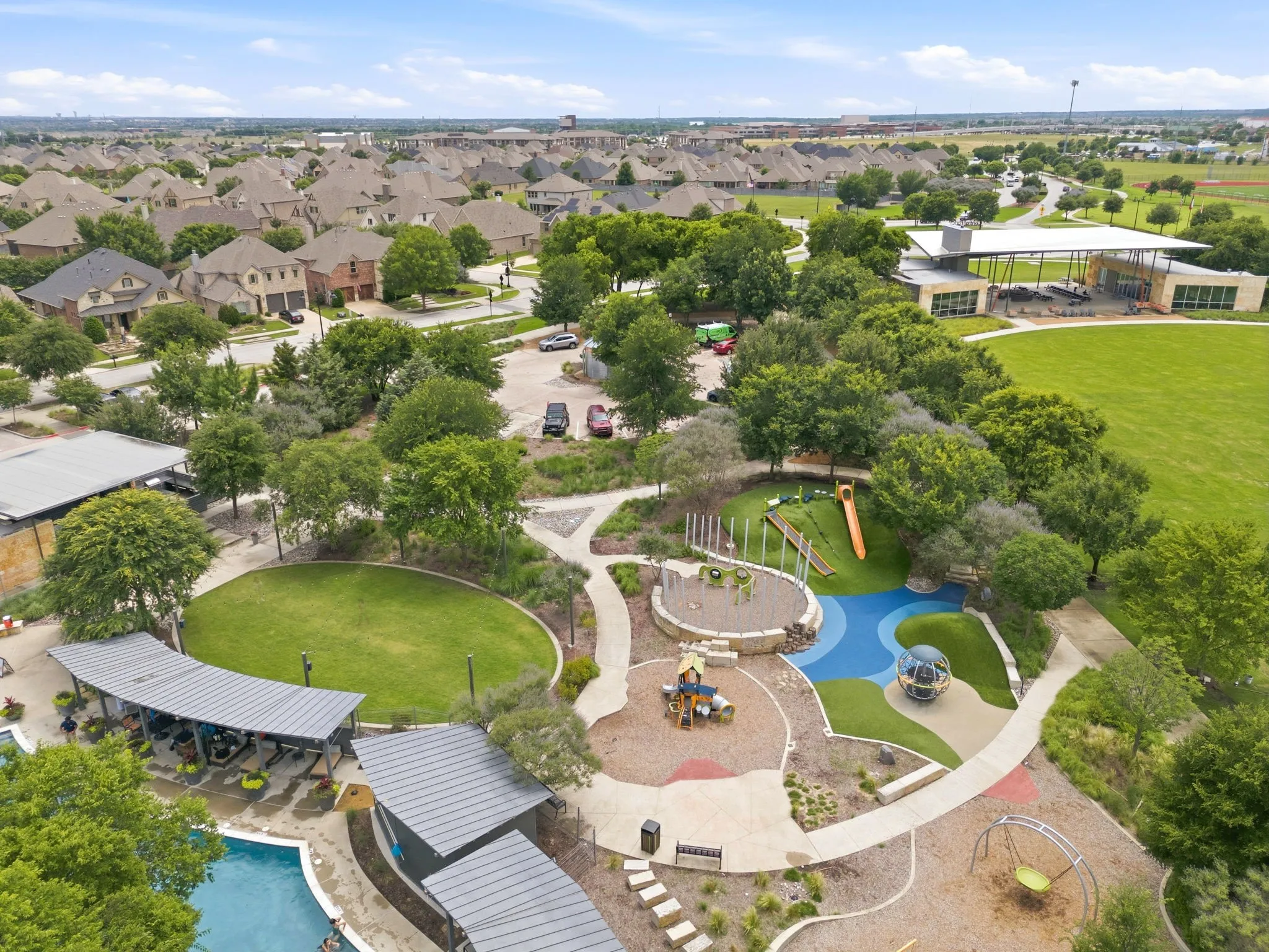 Community pool and clubhouse featuring a contemporary design, multiple lounging areas, and mature landscaping