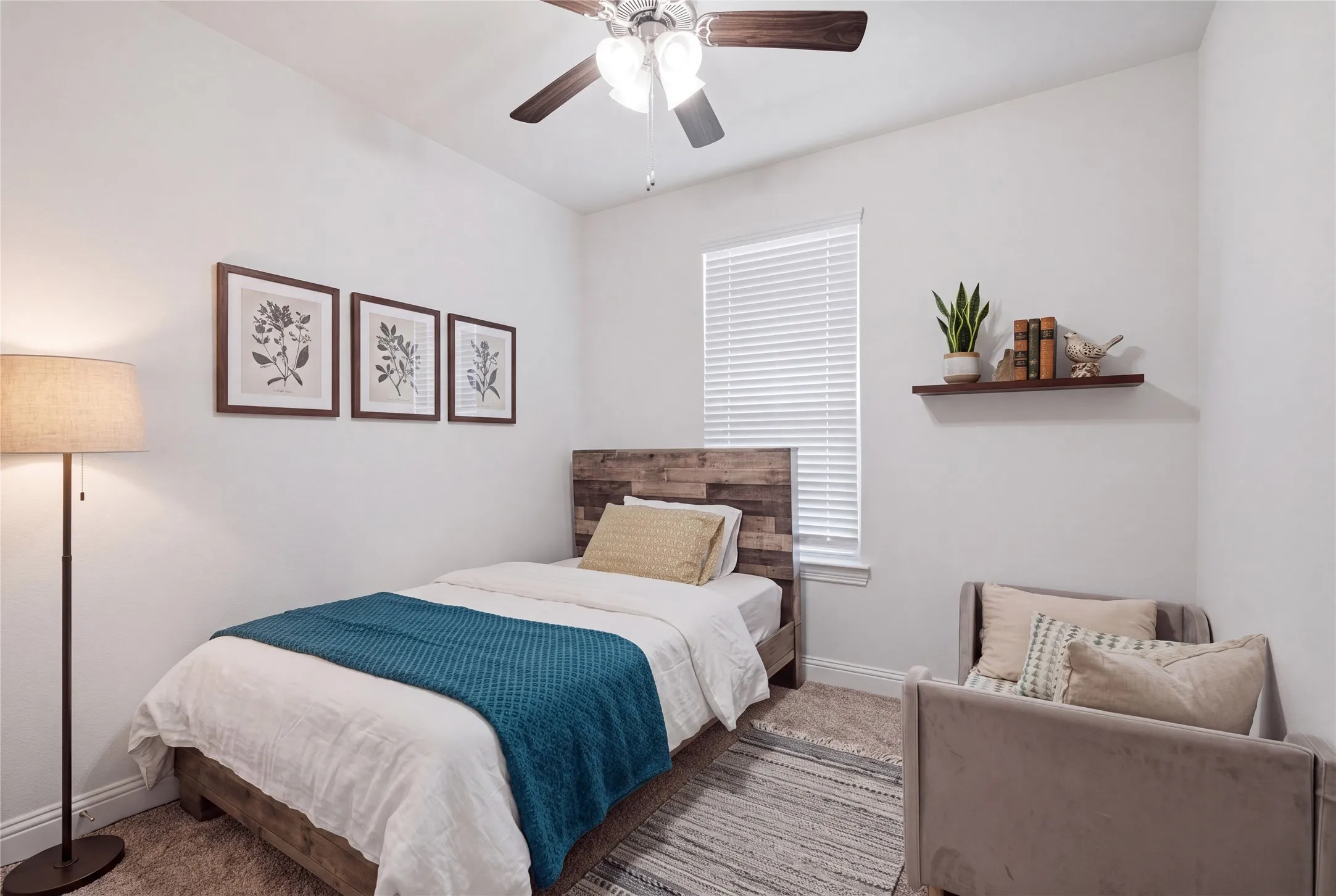 Bedroom featuring a ceiling fan with light fixture, window with blinds, and carpet flooring