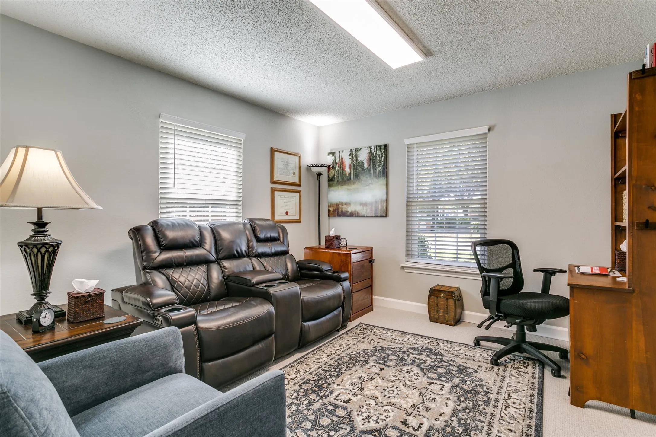 Versatile interior space featuring light gray walls and a textured ceiling