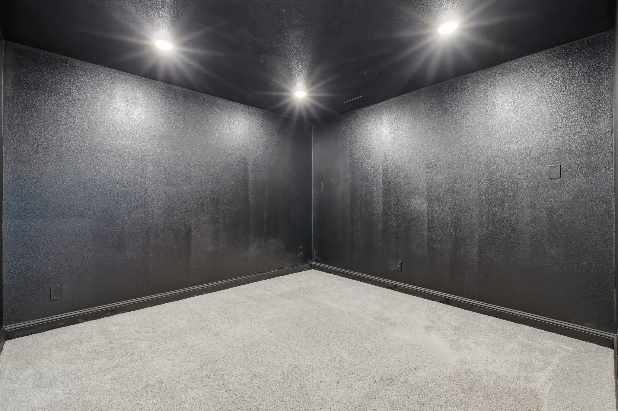 Interior room featuring dark walls, recessed lighting, baseboard molding, and light-toned carpet flooring