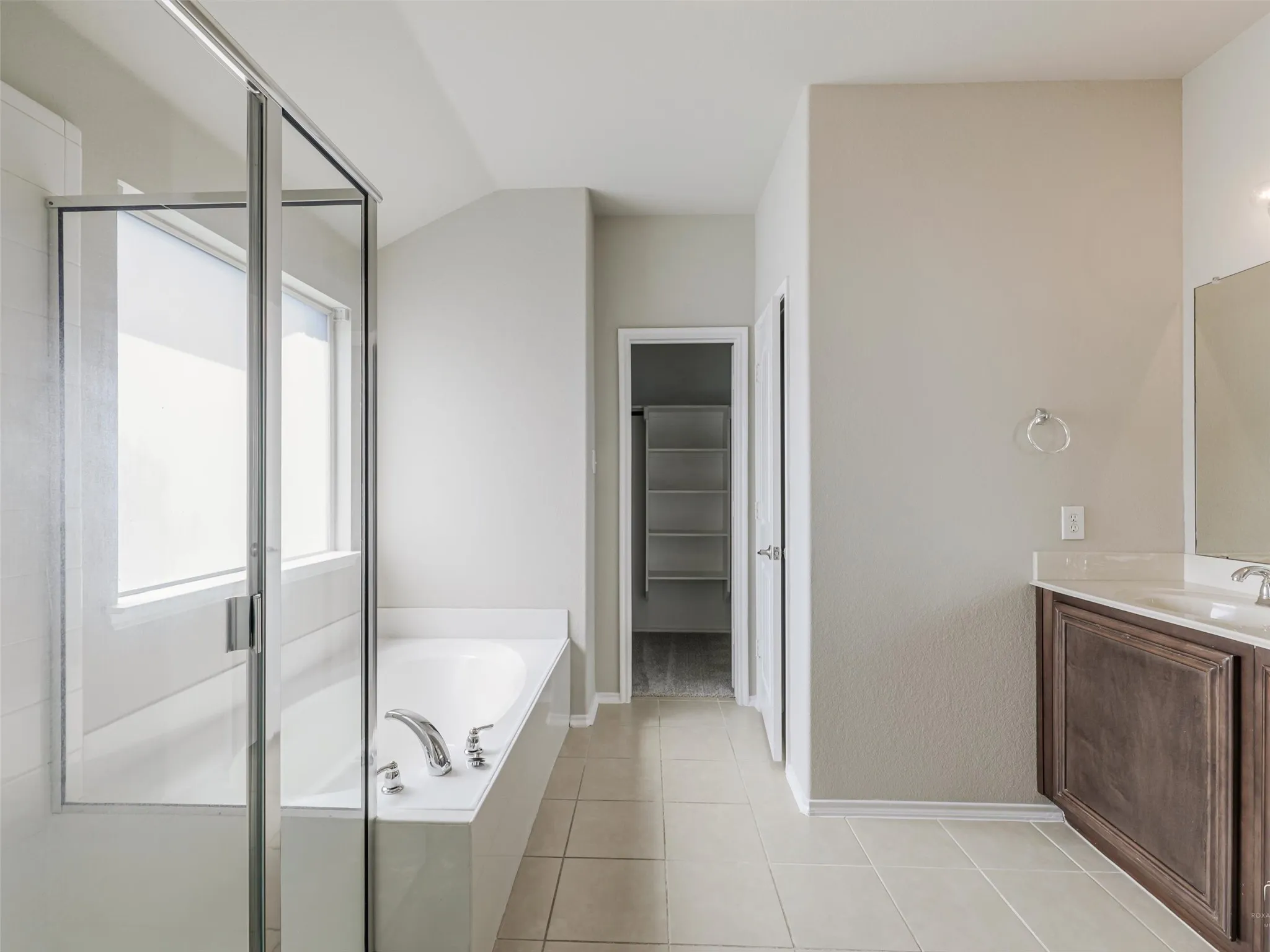 Tiled flooring throughout the bath area
