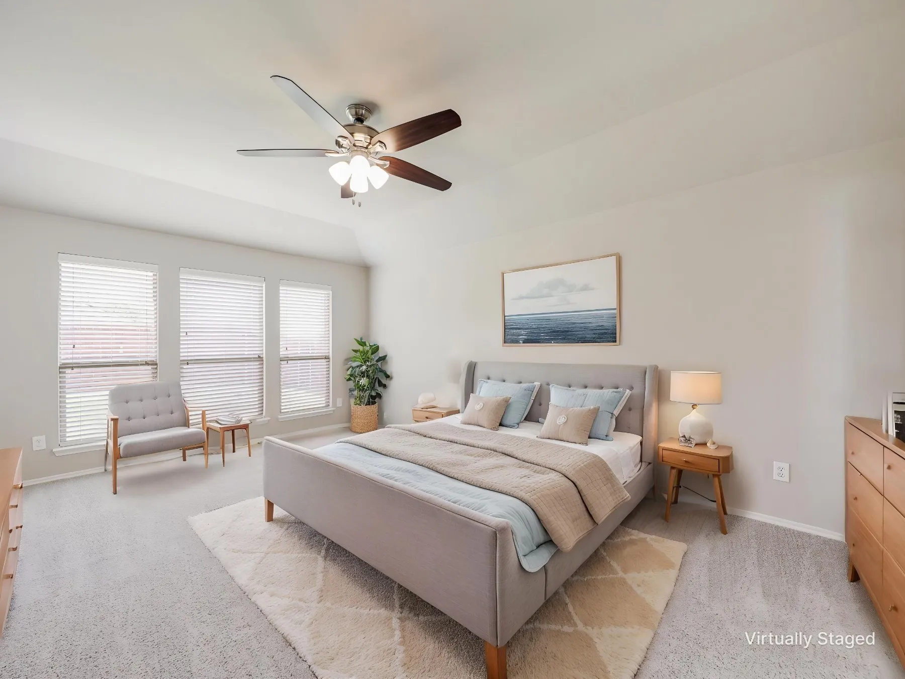 Virtually staged - Bedroom featuring a vaulted ceiling with a ceiling fan, three horizontal windows with blinds, and light-toned carpet flooring