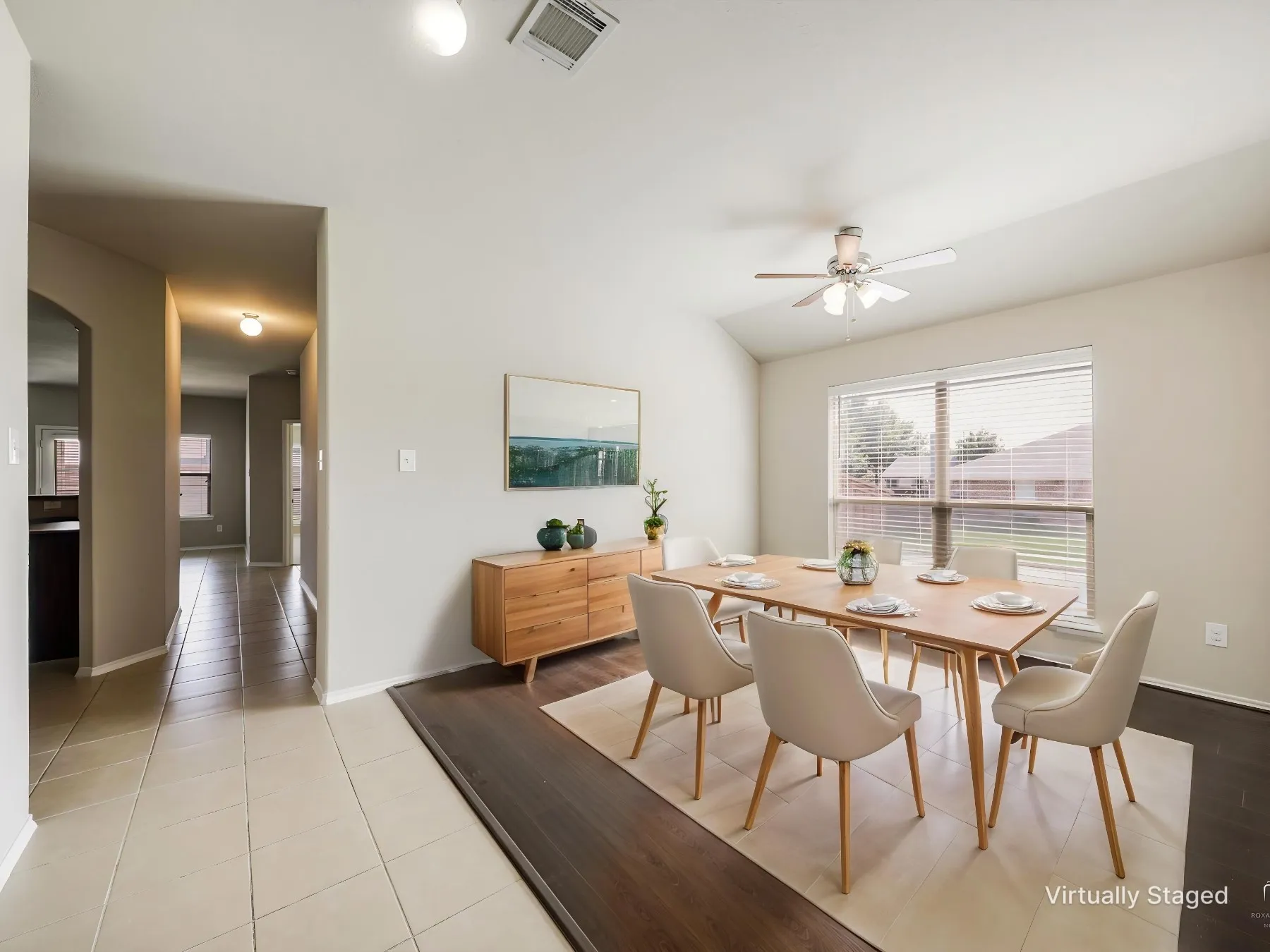 Virtually staged - Dining area featuring vaulted ceilings, a ceiling fan with integrated lighting, and a large window with horizontal blinds