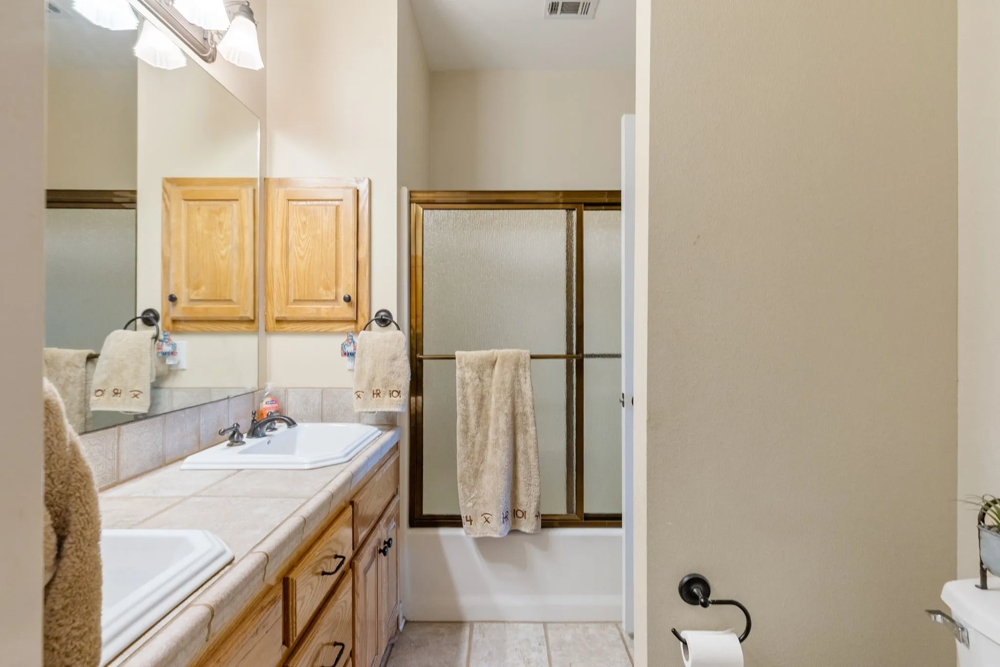 Secondary bath can be accessed off the hallway and one of the bedrooms.