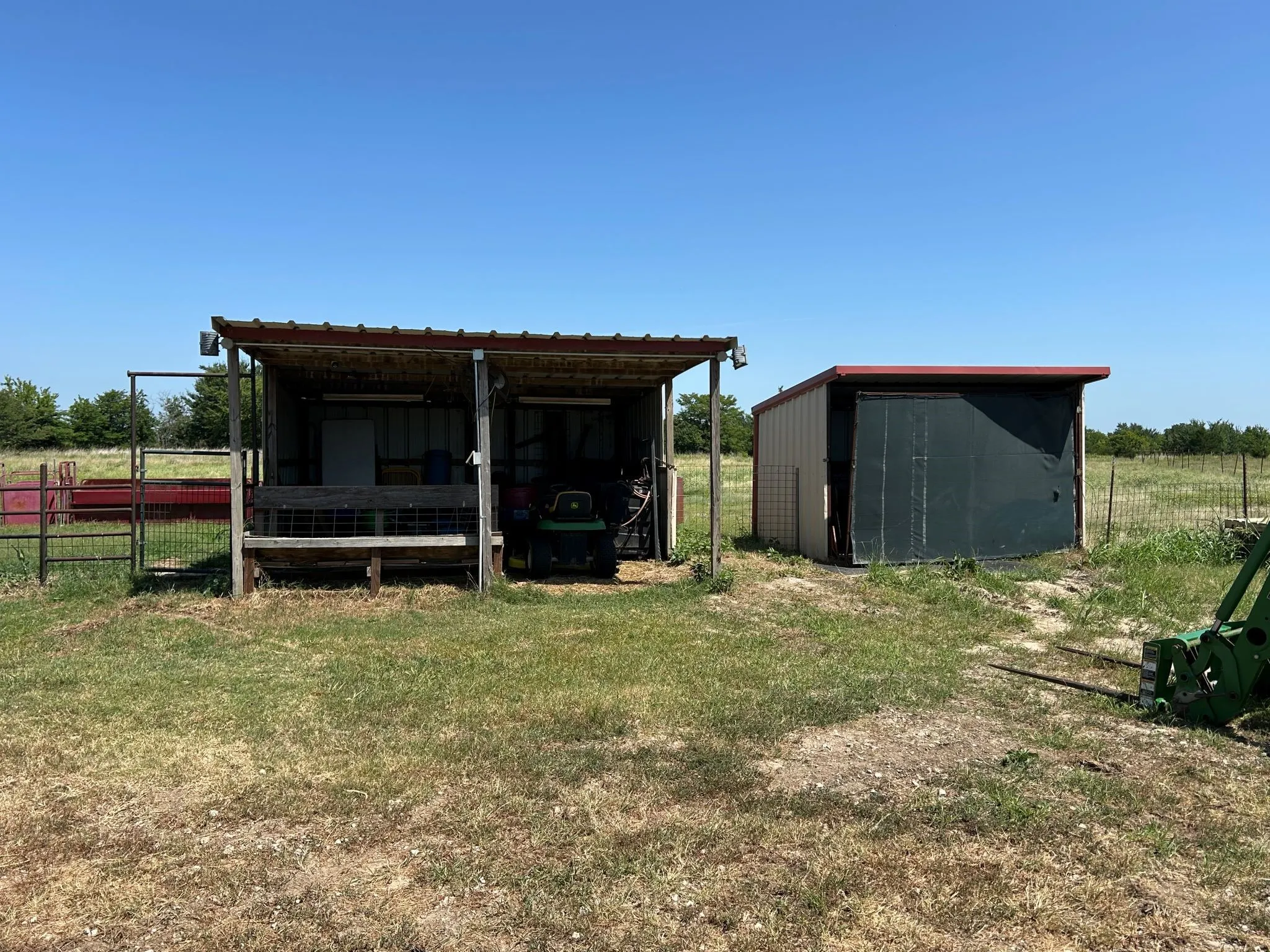 Small seds near the barn provide covered areas for supplies and equipment out of the weather.