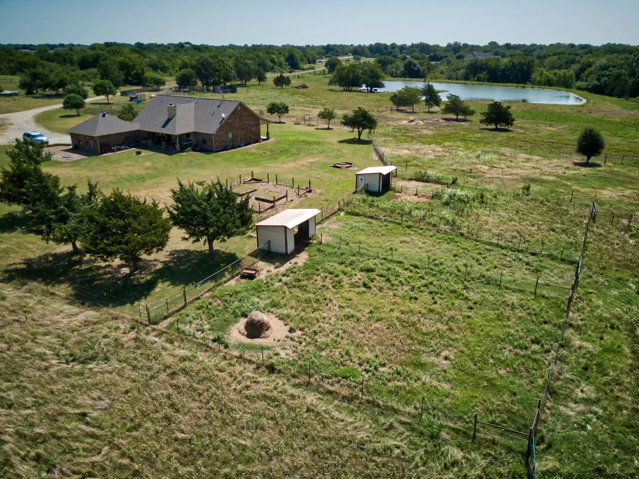 Aerial view of exterior of small loafing sehds with small paddocks.