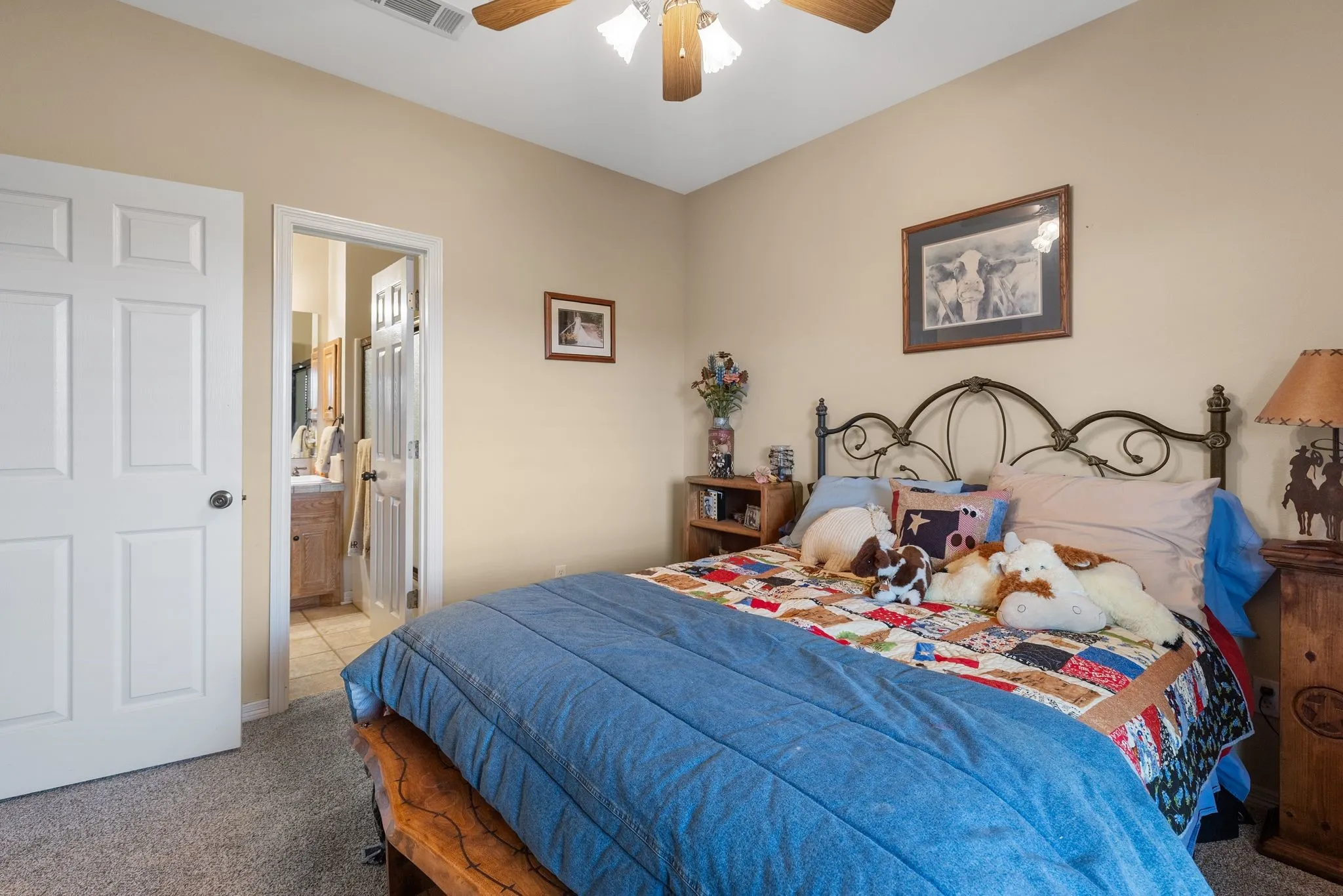 Secondary bedroom room featuring a ceiling fan with light fixture, a window with horizontal blinds, and neutral wall paint