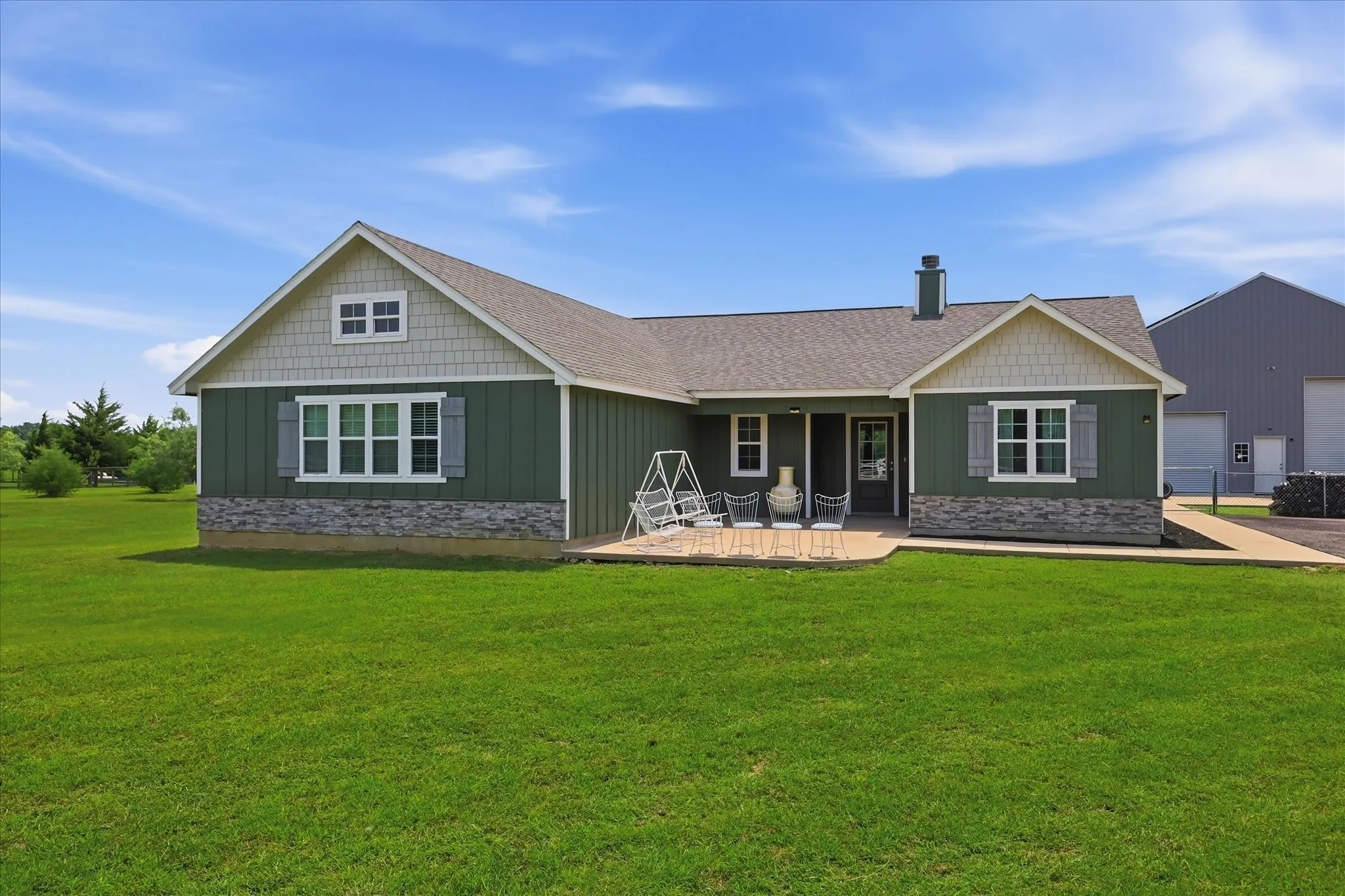 Front of home with a stone facade accent and gabled rooflines