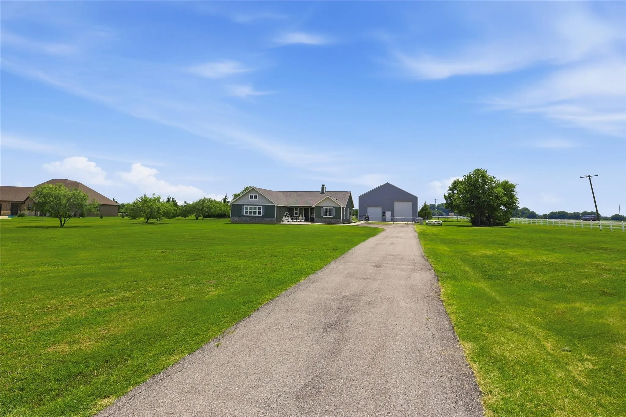 Long paved driveway providing access to the property