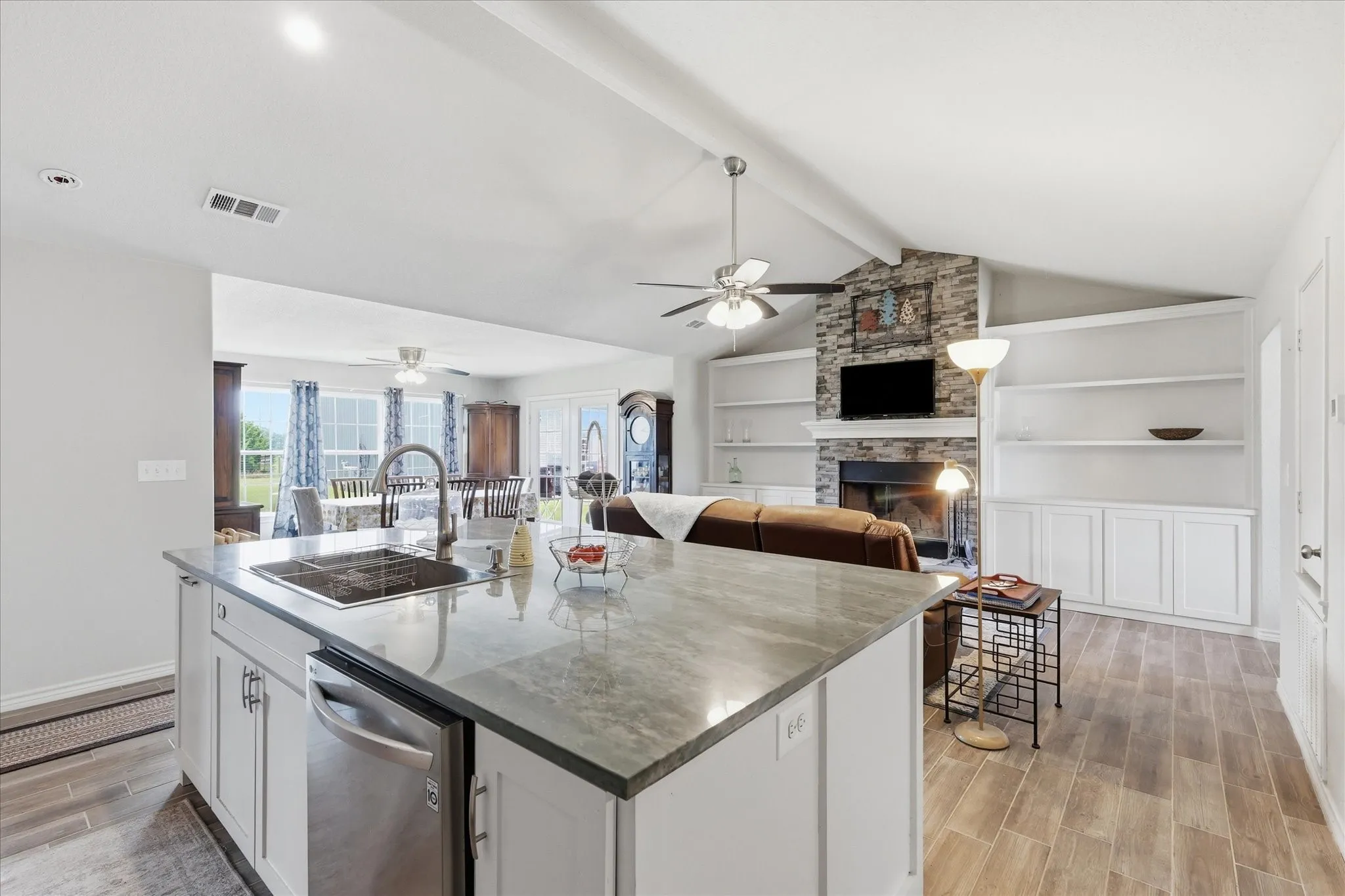 Spacious kitchen island with an undermount sink and stainless steel dishwasher