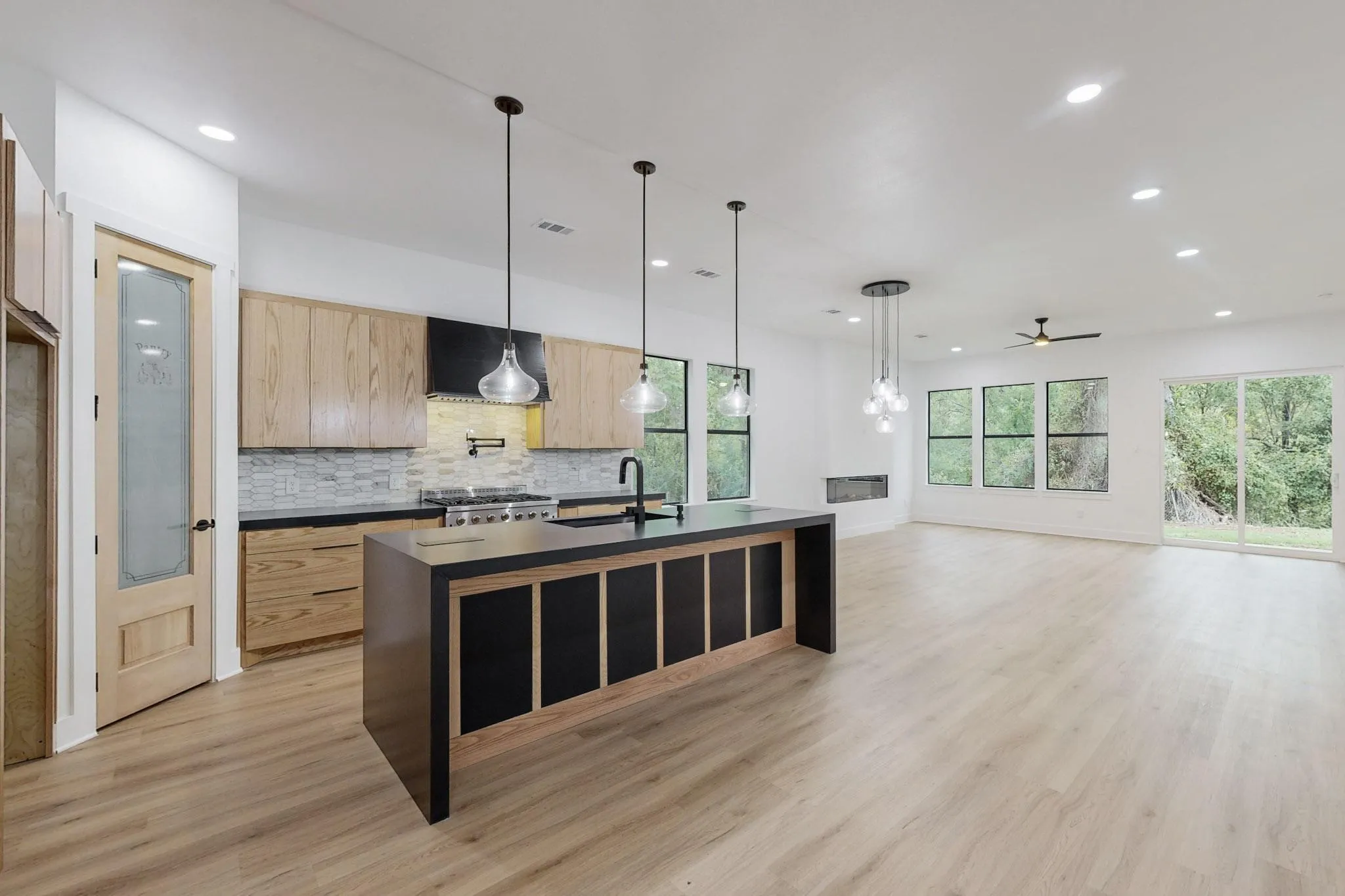 Open-concept living space with wood-finish flooring