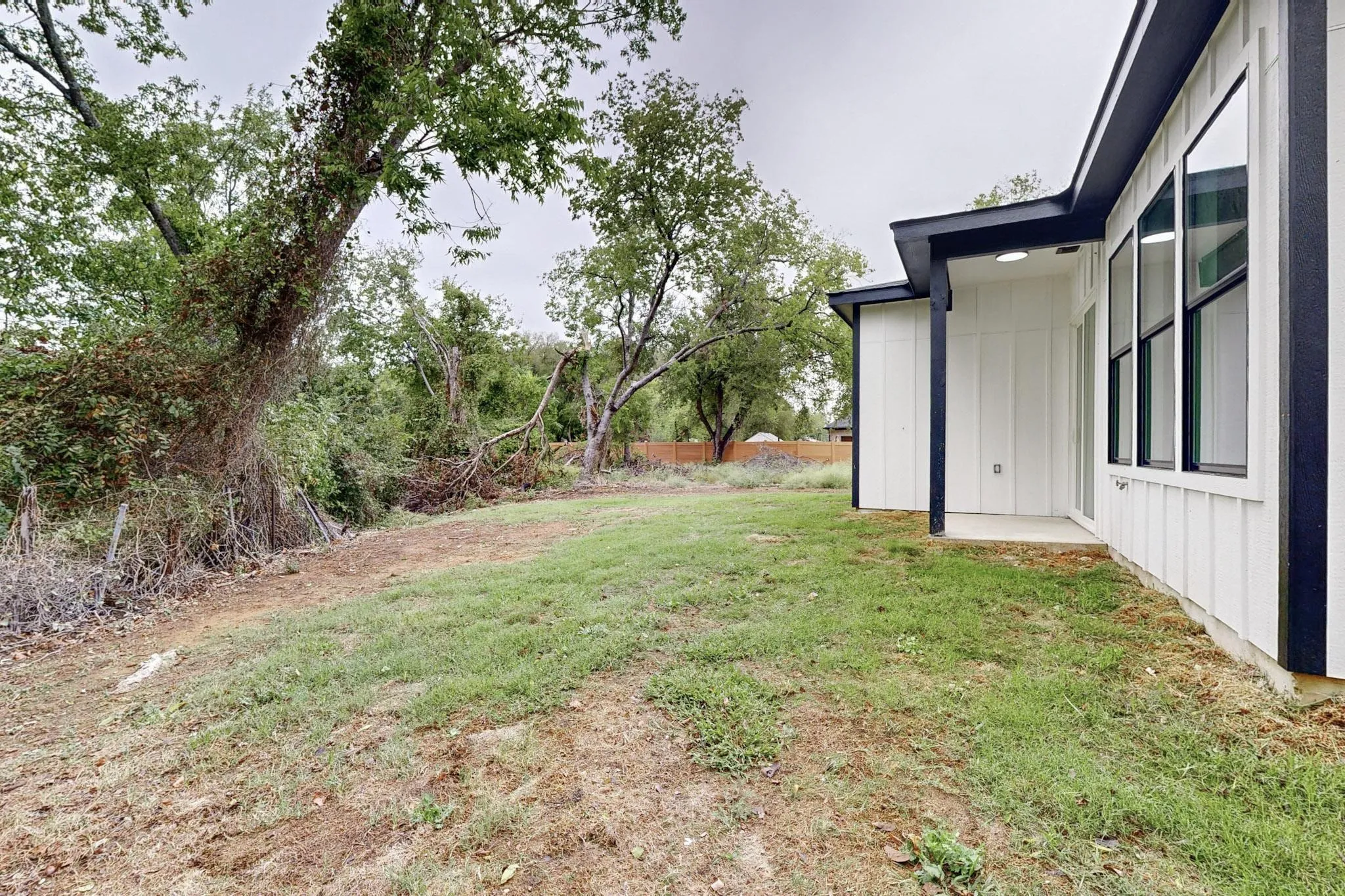 Contemporary exterior featuring white vertical siding and black trim