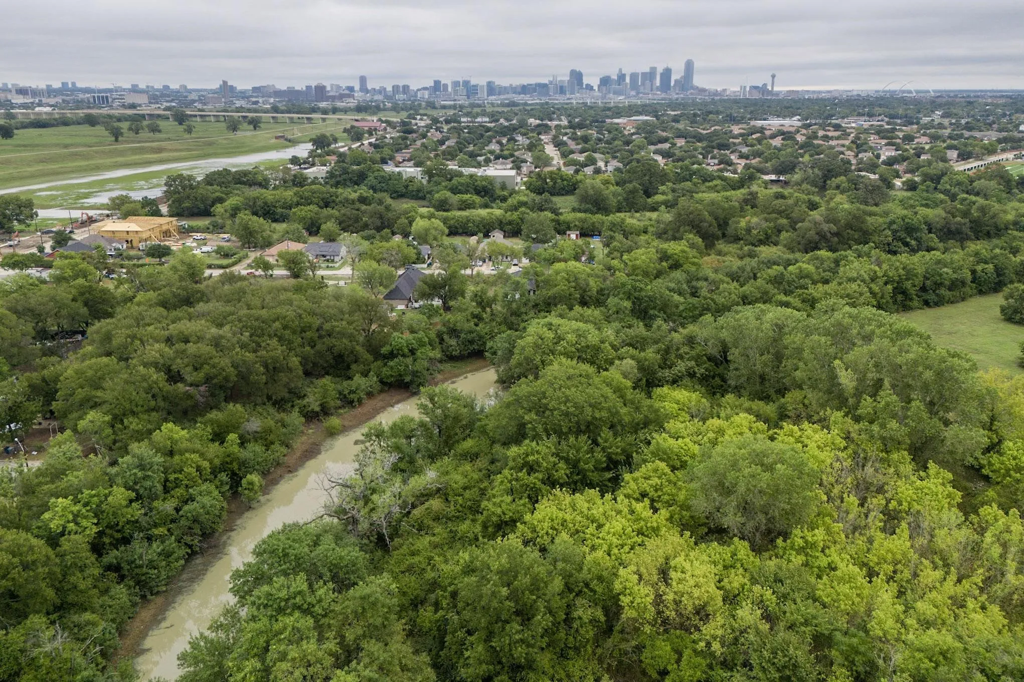 Expansive natural setting featuring dense tree cover and a winding waterway