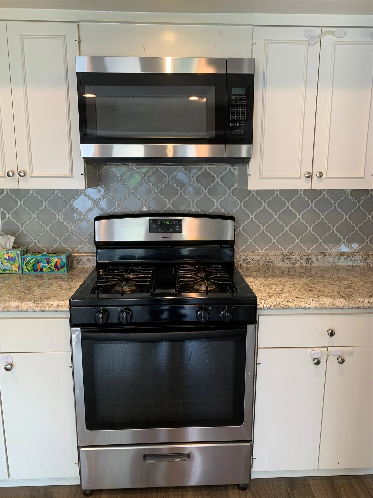 Stainless steel gas range with a coordinating over-the-range microwave
