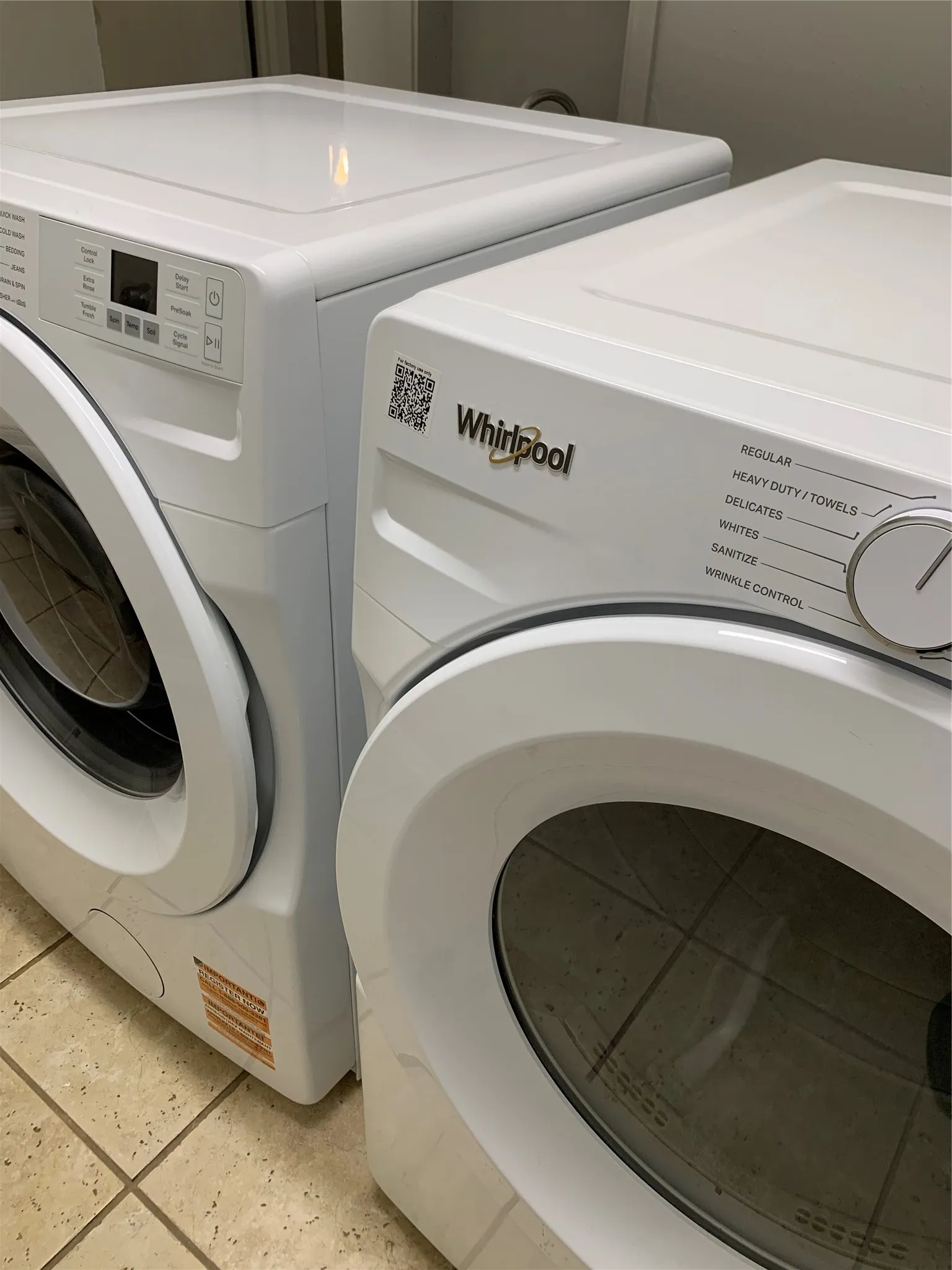 Whirlpool front-loading washer and dryer set with tile flooring