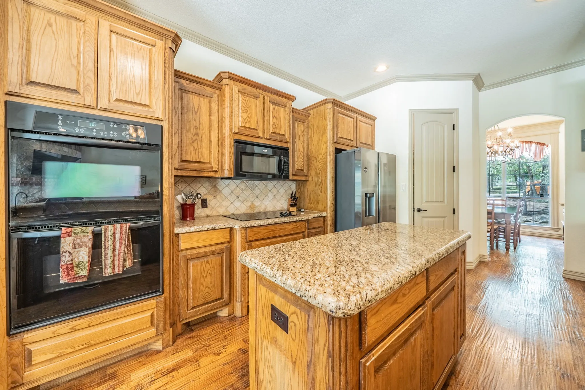 Black appliances with double ovens. Walk in pantry.