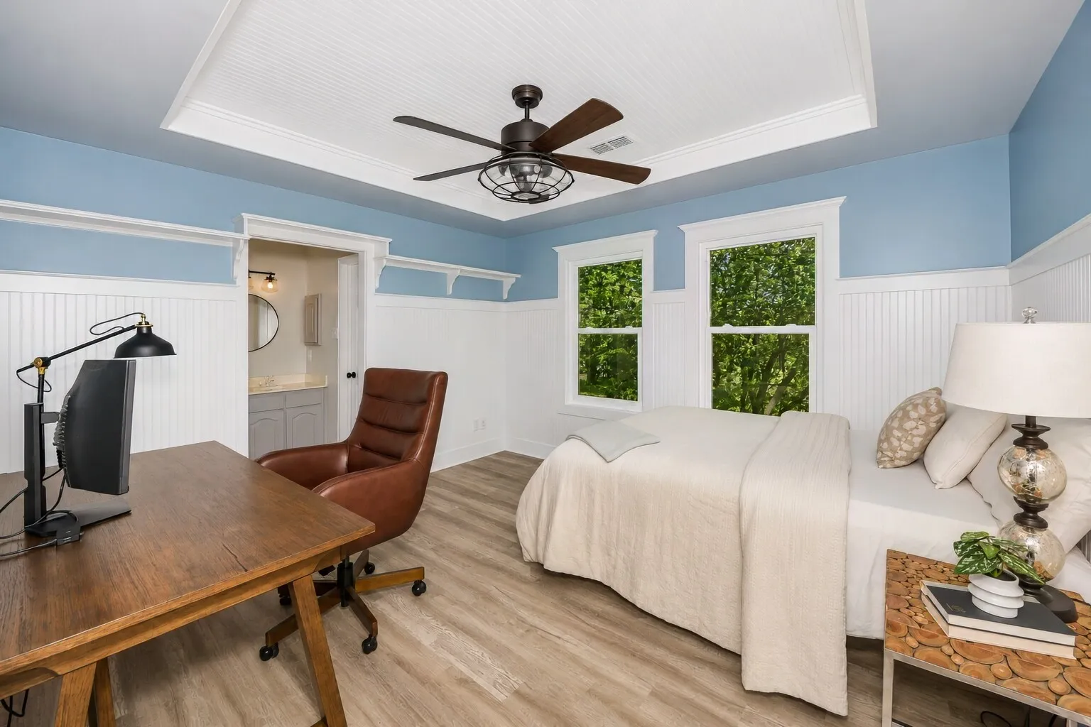 Bright and inviting, this secondary bedroom blends modern farmhouse trim with large windows that pull in soft natural light throughout the day. The layout feels flexible — just the right size for a teen retreat, a cozy guest room, or a quiet study space tucked away from the main living areas. Direct access to the Jack-and-Jill bath gives the room a comfortable, connected feel, making it a standout space for anyone who wants privacy without feeling closed off.