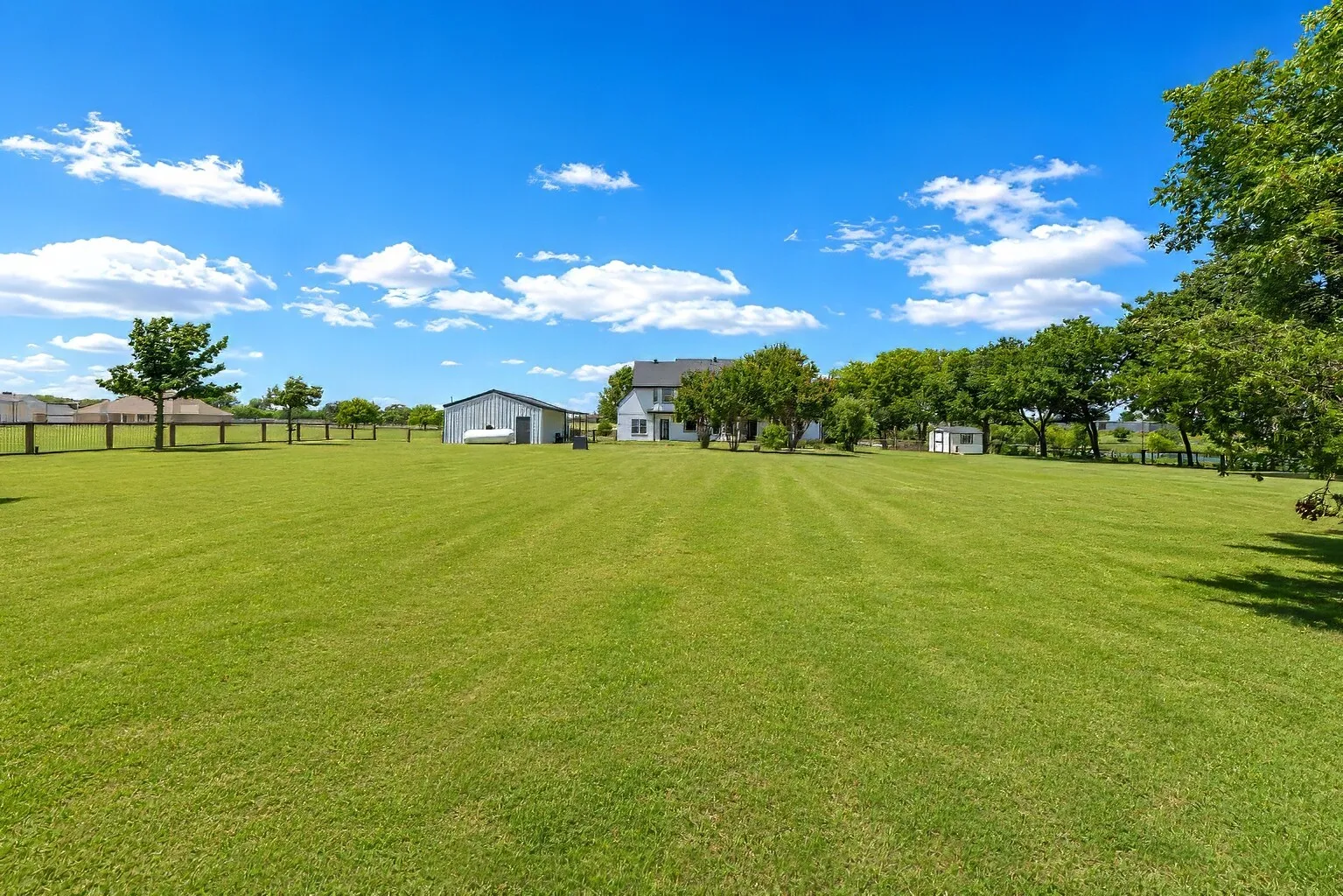 The expansive backyard opens into wide green space perfect for modern homesteading — plenty of room for a vegetable garden, fruit trees, and even a small flock of chickens. The property layout easily accommodates a full-size pool and pavilion, giving you space to create an outdoor retreat for gatherings and summer evenings. There’s also room for sand volleyball, adding a fun, active element to the yard. With mature trees and open land stretching in every direction, it’s a peaceful setting designed for both everyday living and weekend enjoyment.