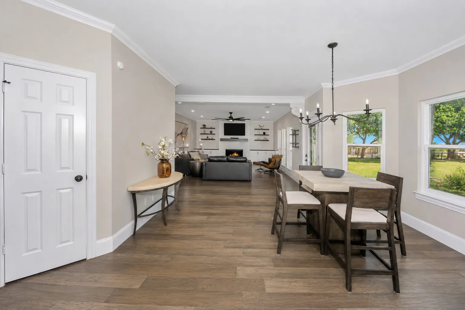 This angle shows how the breakfast area connects seamlessly to the living room, keeping the whole space bright and open. The windows pull in those backyard views, and the door to the left leads to a large walk-in pantry, making everyday cooking and storage easy. It’s a comfortable, connected spot that sits right at the heart of the home.