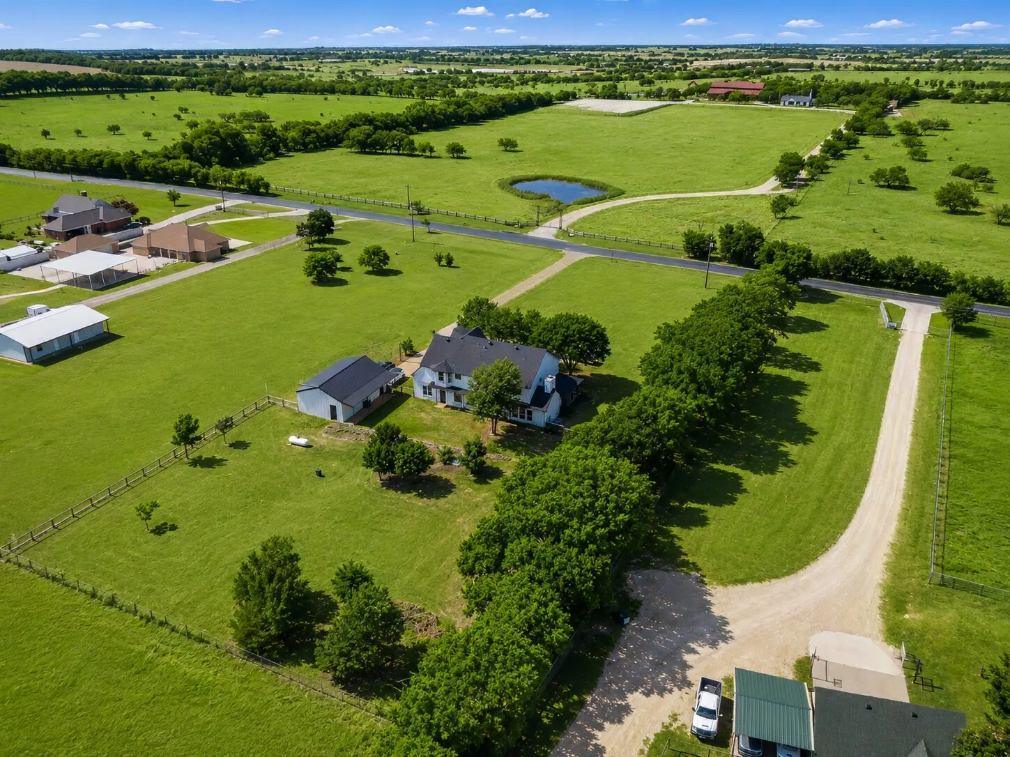 North View-Shows the full tree line, backyard, north fence line, and views of the neighboring homes to the east, west and north across the steet.