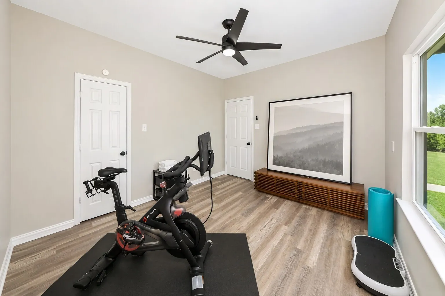This downstairs bedroom sits just off the kitchen at the back of the home, making it an easy space to use every day. It’s currently set up as the owners’ gym retreat, with room for equipment and a quiet spot to reset. The full closet keeps it a true bedroom, and the full bathroom right next door makes it a great option for multi-generational living or a private guest space. It’s a flexible room that adapts to whatever someone needs — fitness, family, or a comfortable place to stay.