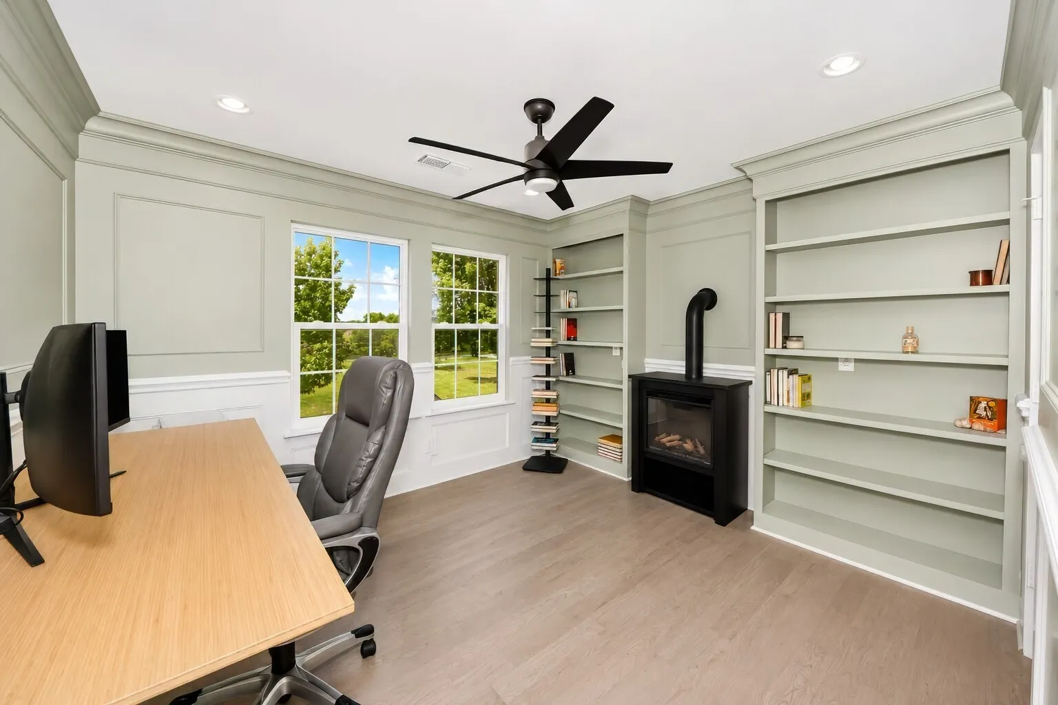 Upstairs, this flexible room works beautifully as a home office, reading retreat, or additional bedroom. Built-in bookcases add character and storage, while the large windows bring in soft natural light and overlook the property. The closet makes the space fully functional for guests or family, and the overall layout gives the room a calm, tucked-away feel that adapts easily to work-from-home days, hobbies, or a quiet getaway.