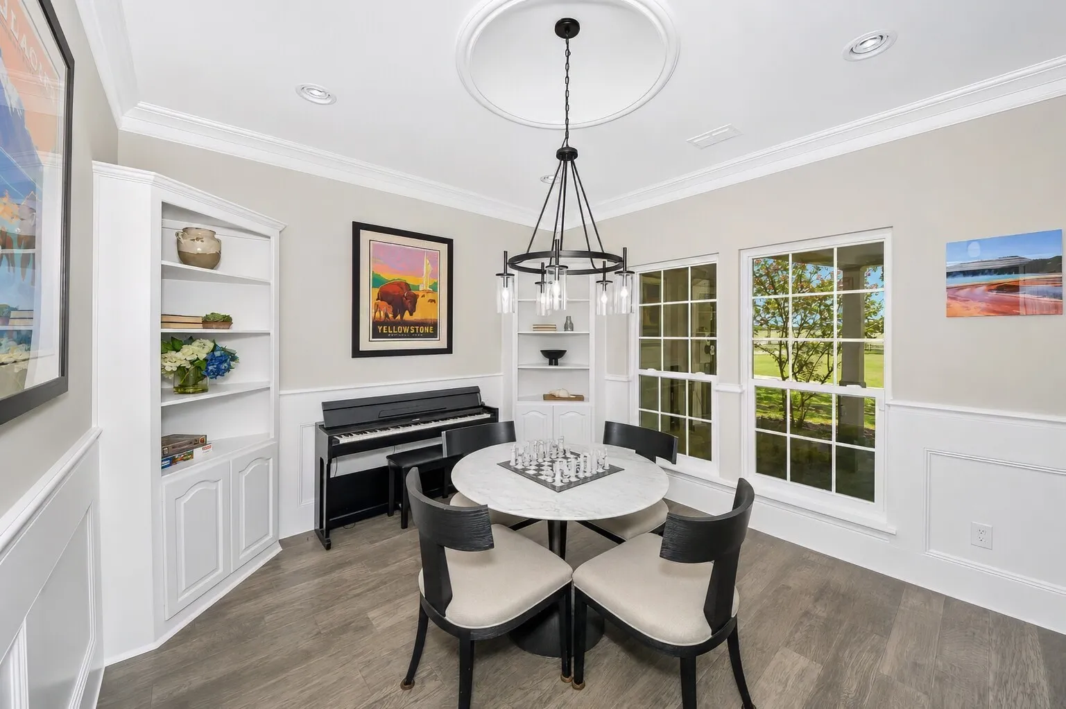 This den is set up perfectly for game nights, with built-in cabinets that keep all your favorite games and puzzles organized and easy to reach. The space feels bright and relaxed, designed for low-key evenings where everyone can gather around the table or spread out comfortably. It’s a practical, everyday hangout that fits the way families actually live.
