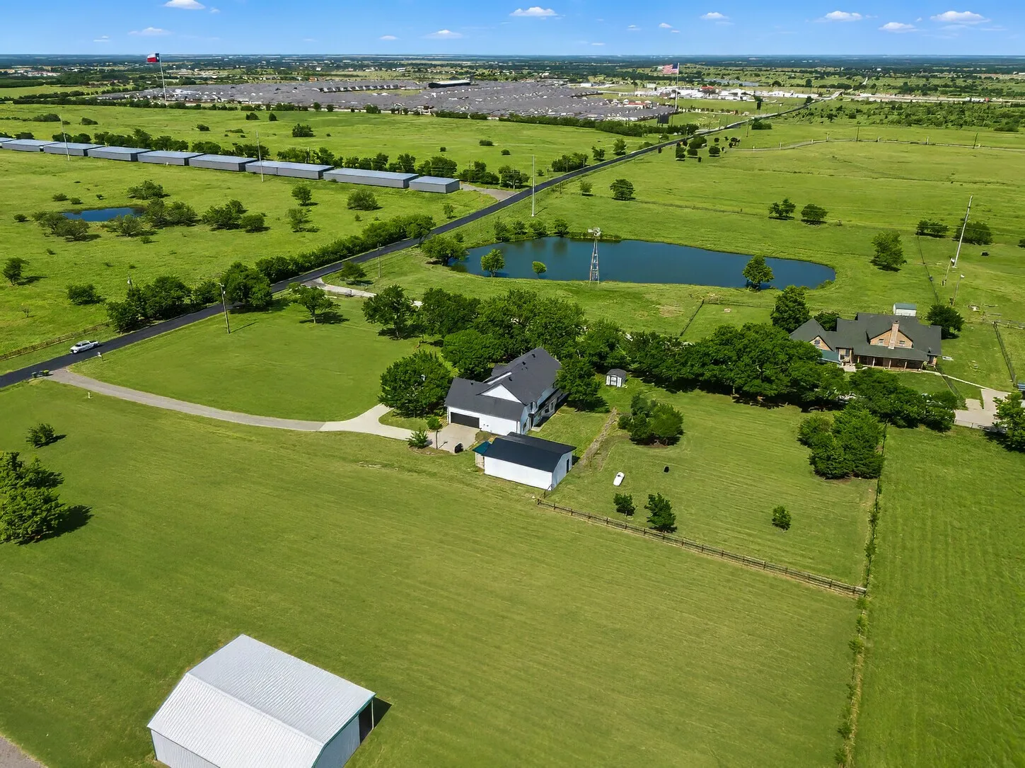 East View-Shows the neighbor's pond, east tree line, full fence line, and clear views of both the front and back yard.