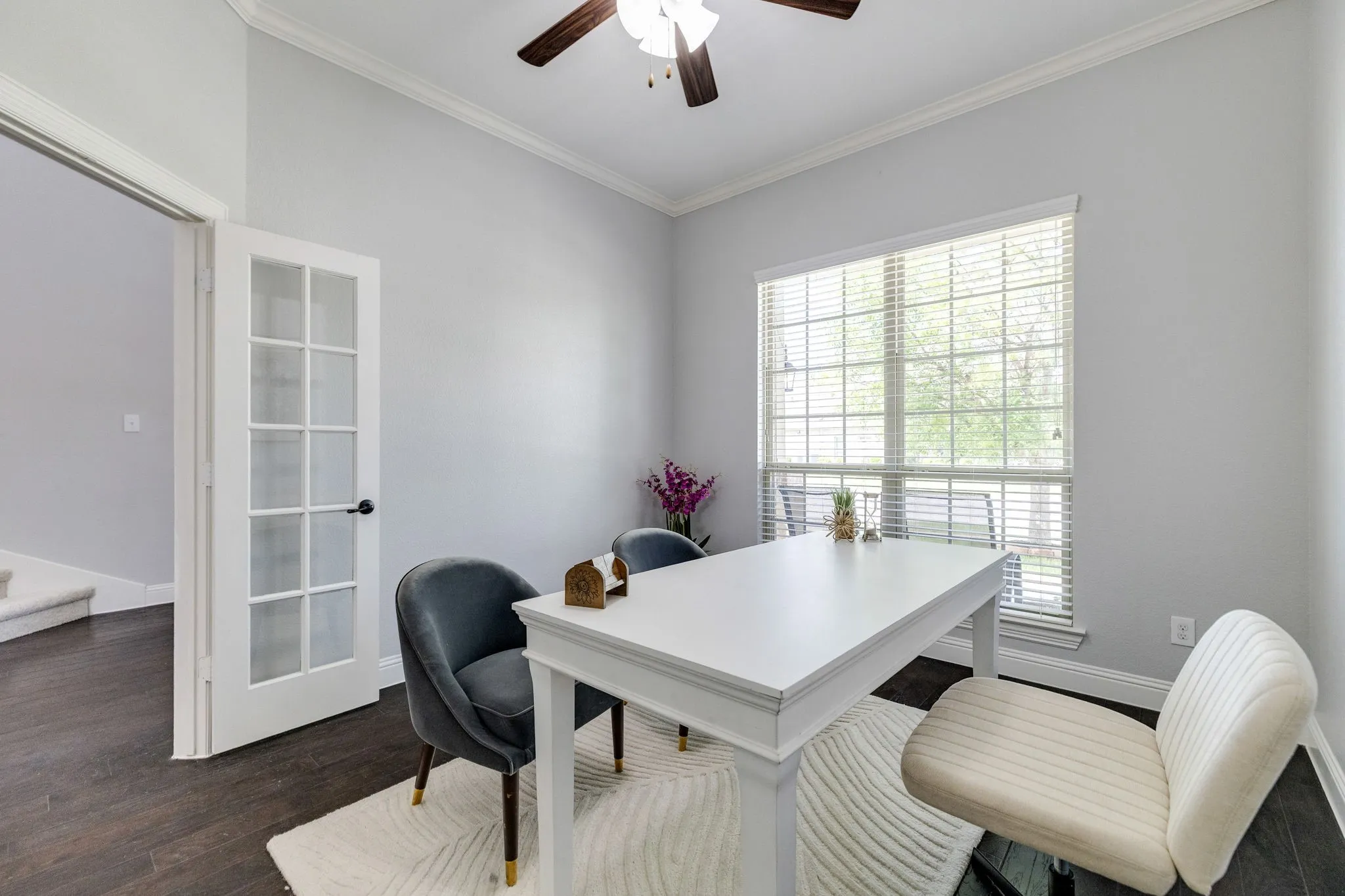 Dedicated space featuring French doors, a large window with blinds, dark wood-finish flooring, and crown molding