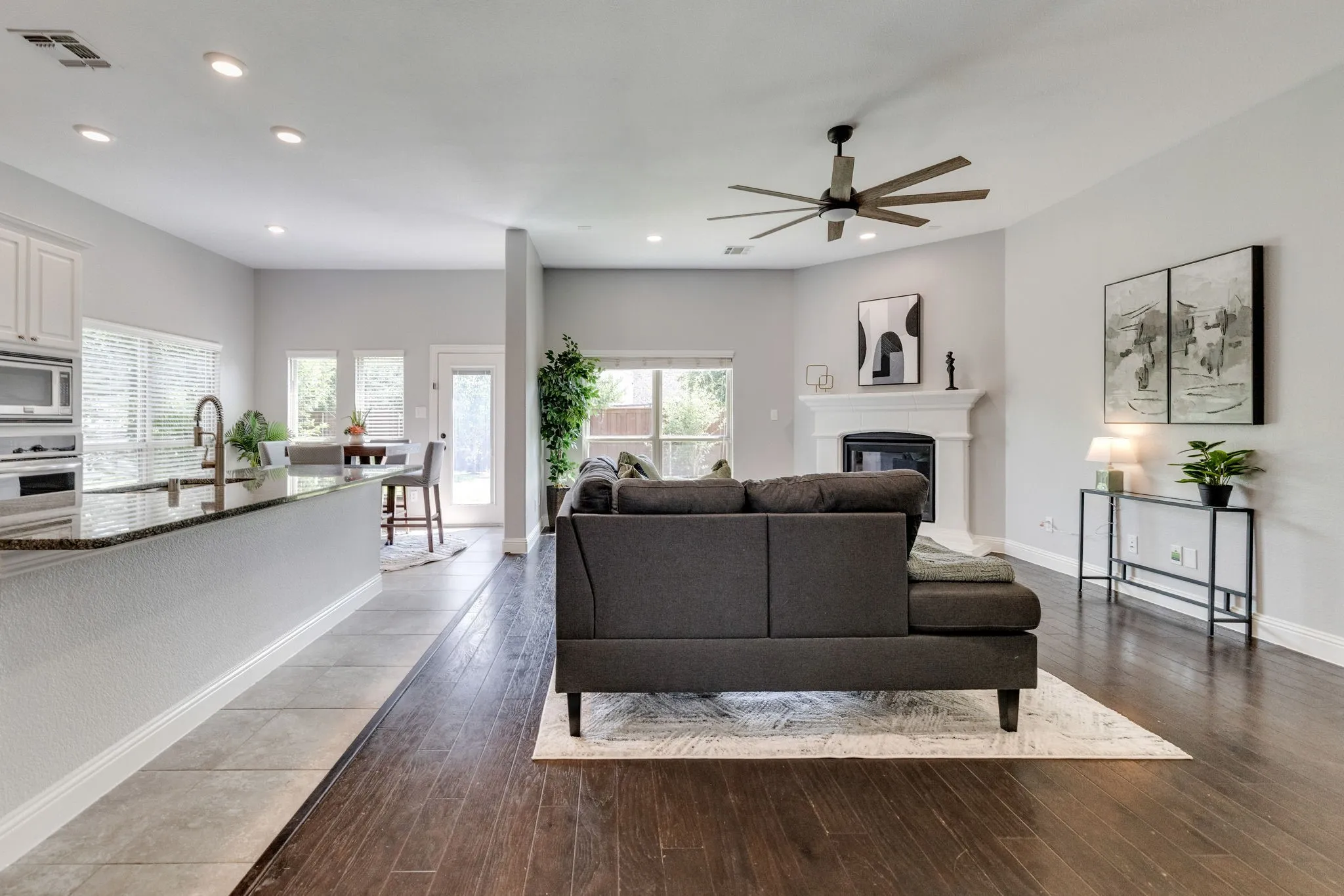 Open-concept living space featuring wood-finish flooring, recessed lighting, and a modern ceiling fan