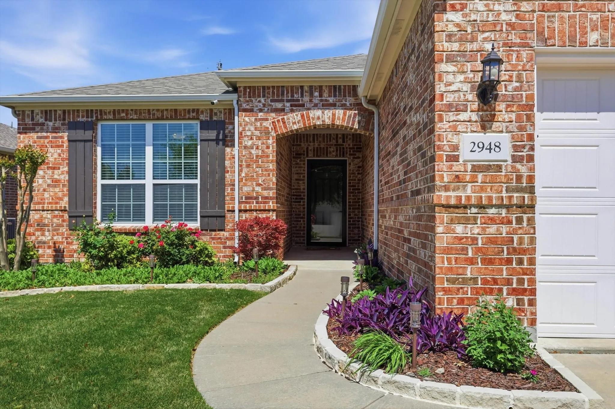 Charming curb appeal welcomes you home with a well maintained lawn and classic brick exterior.