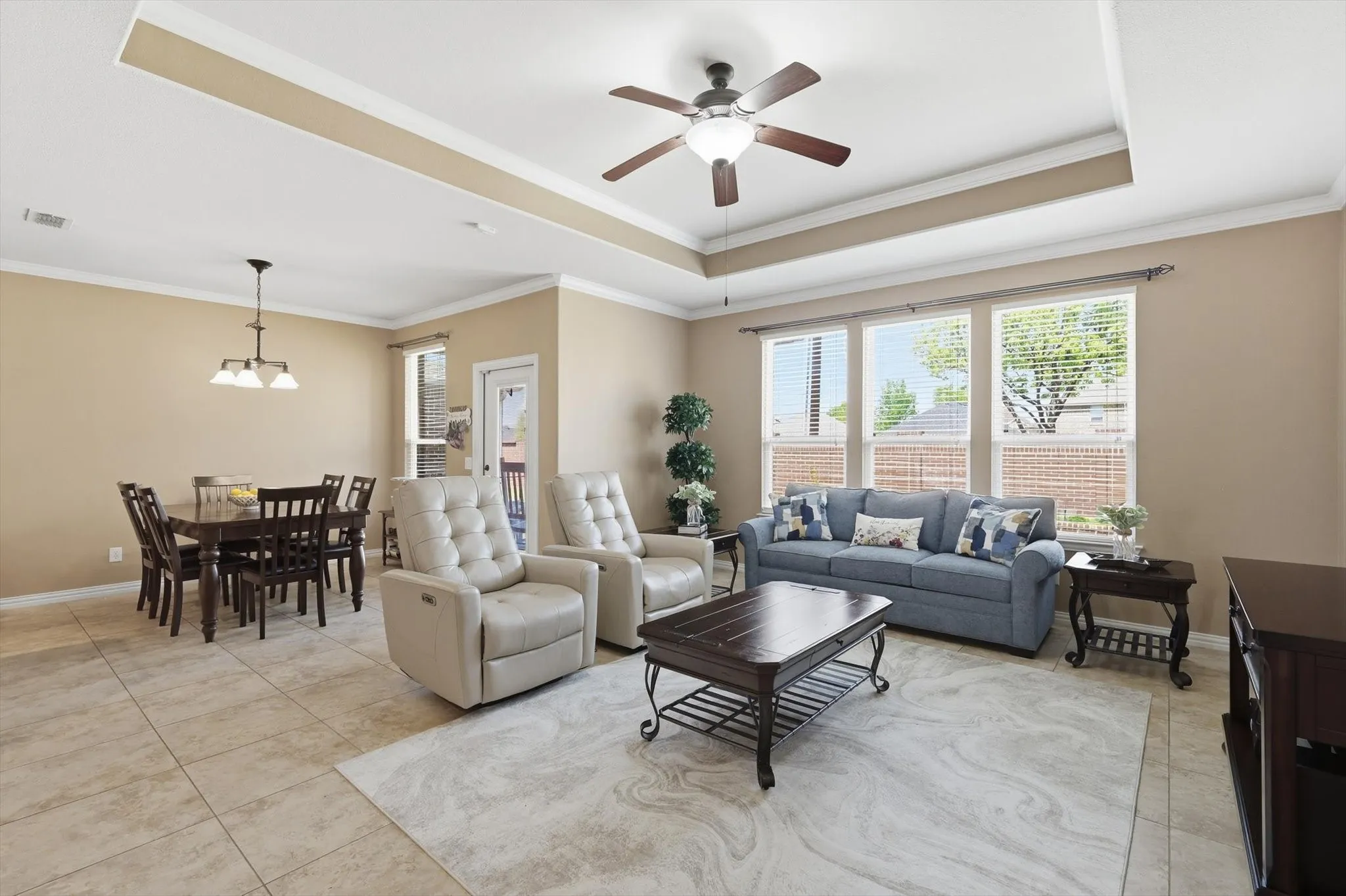 Open concept living space with large windows and comfortable flow into the main areas.