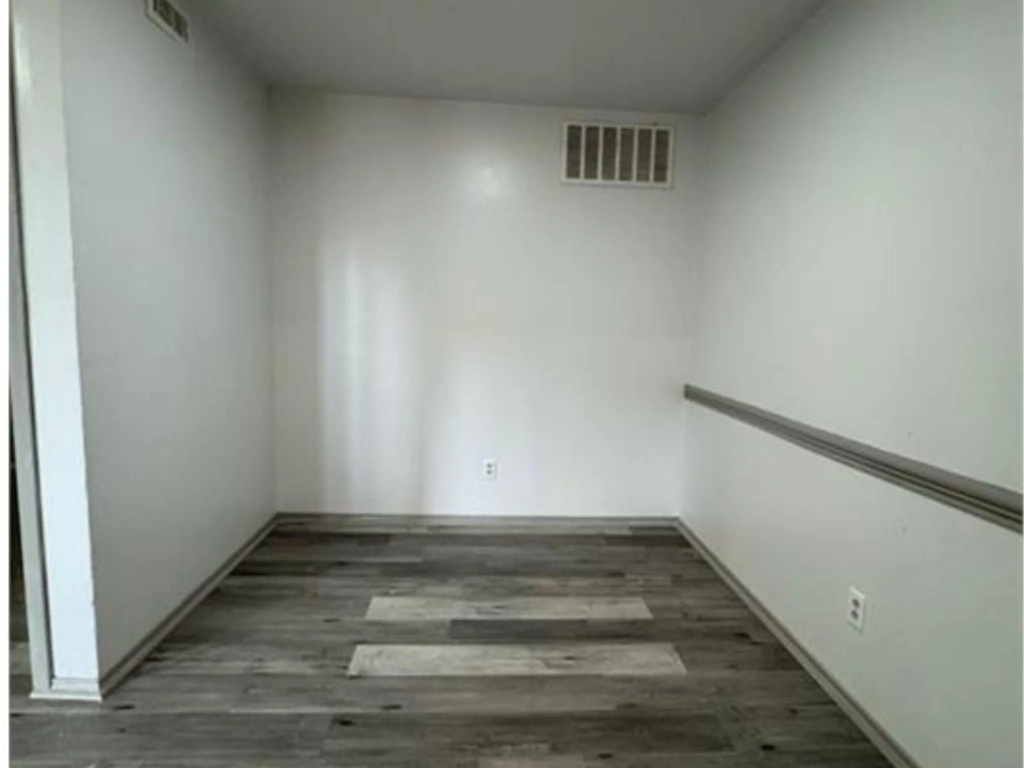 Interior space featuring wood-finish flooring and chair rail molding