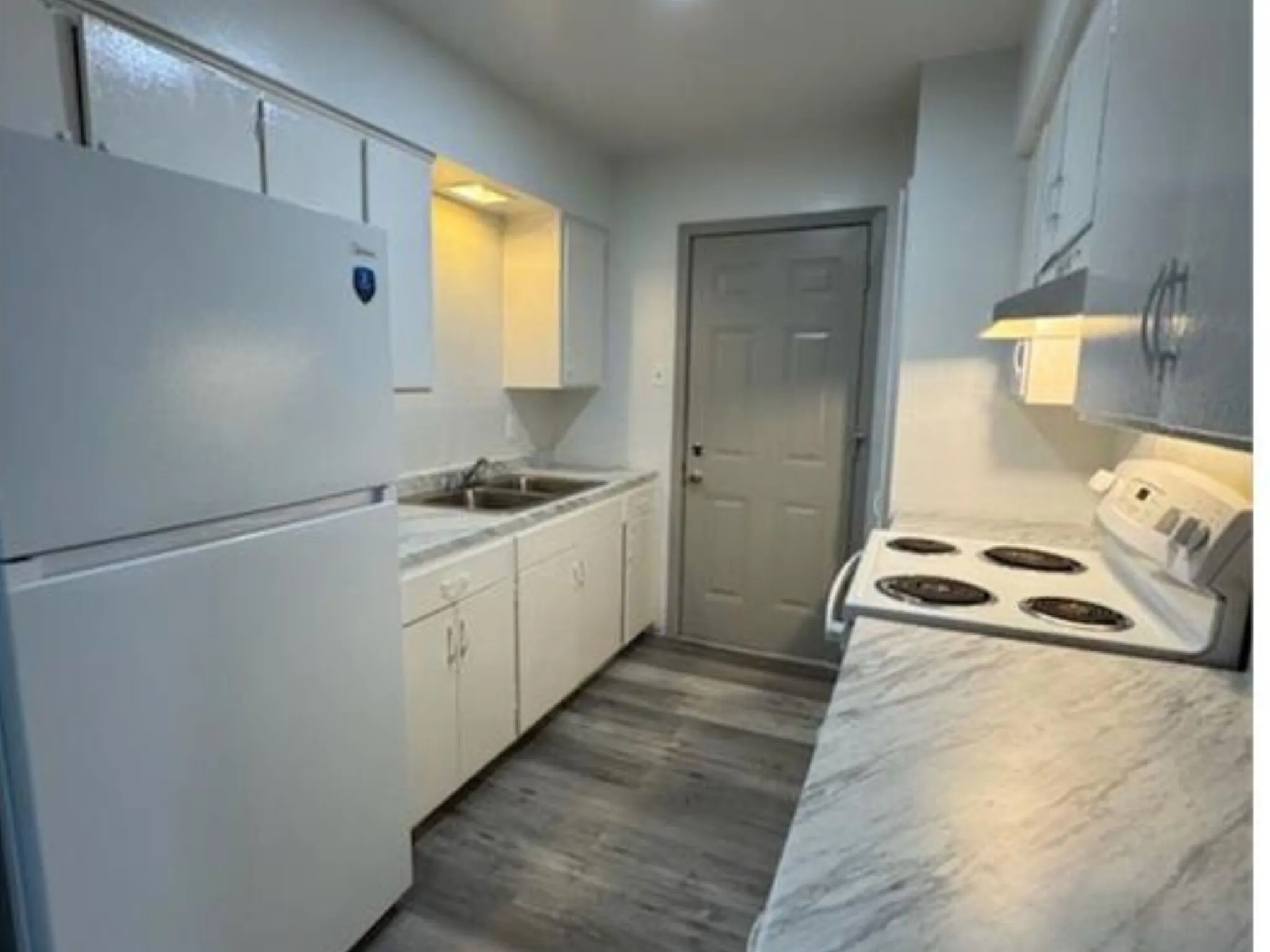 Kitchen features sleek countertops and a functional layout with ample storage and prep space.