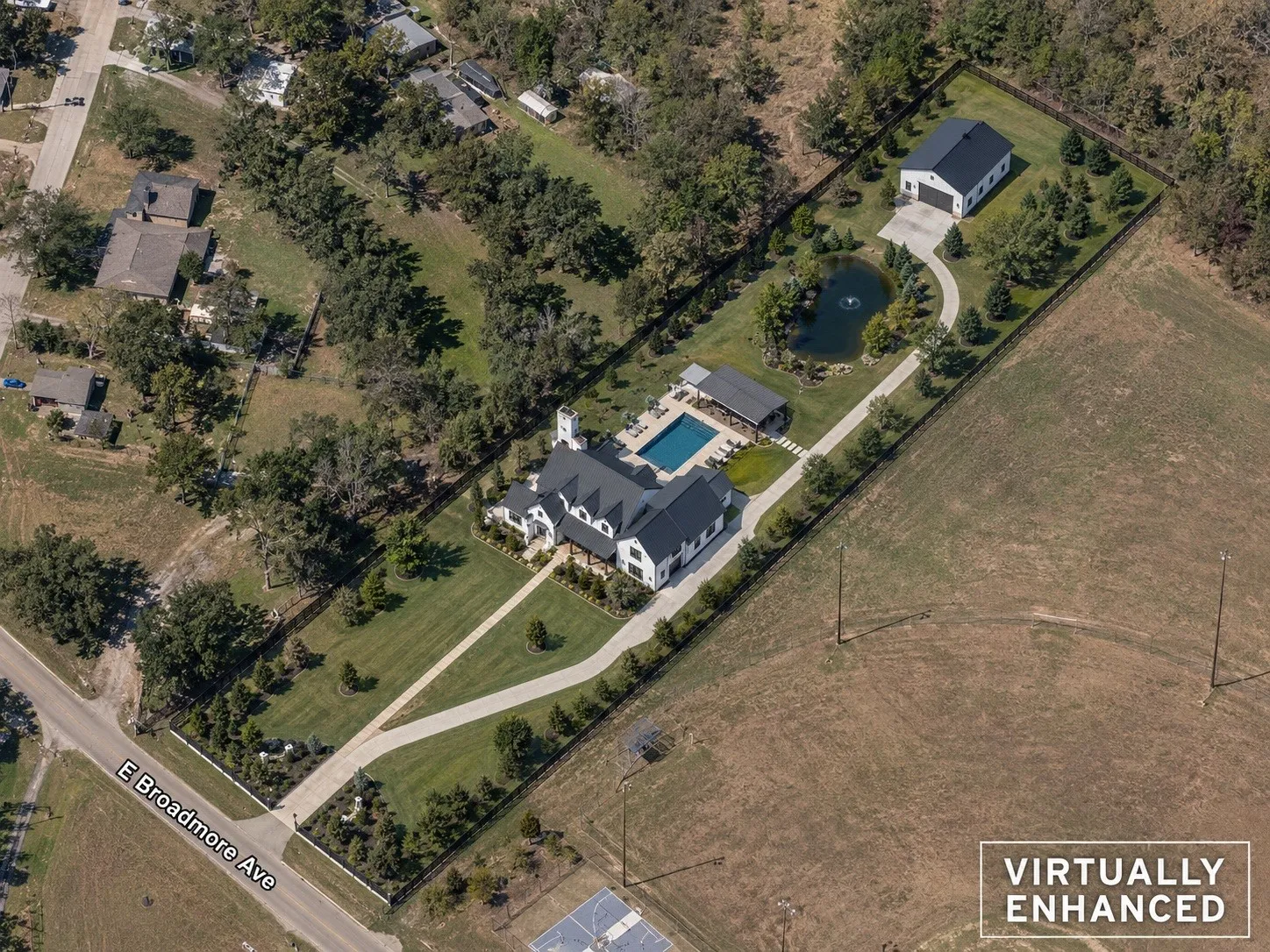 Unimproved property - This is an example of an Expansive property featuring a main residence, detached garage with a separate driveway, private swimming pool, and a pond with a water feature - virtually staged