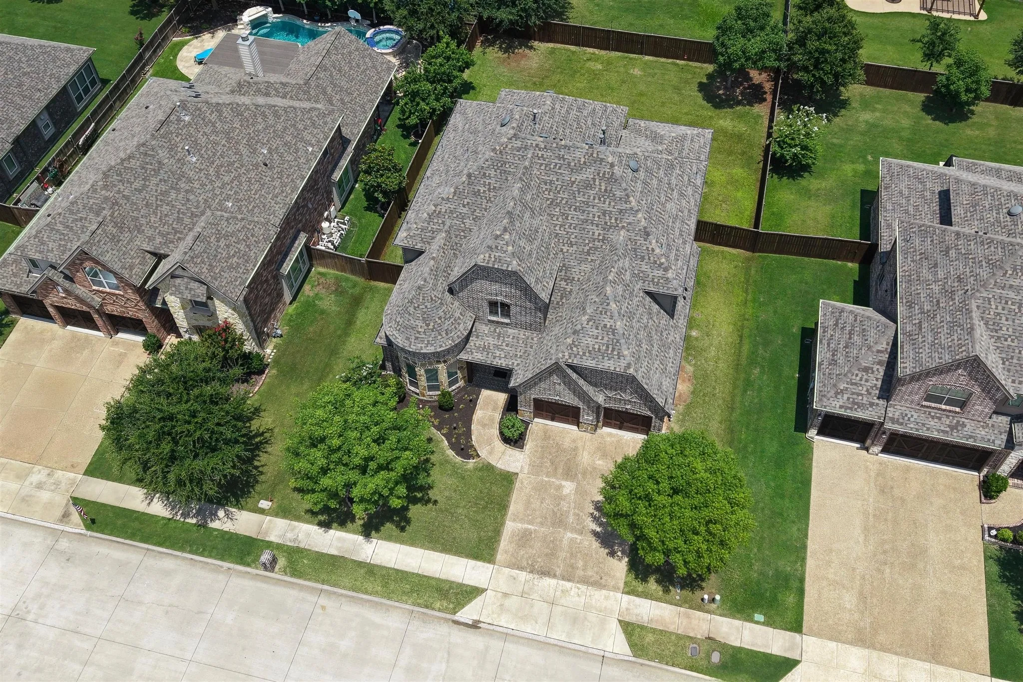 Overhead perspective showcasing a residential property with a multi-gabled roofline