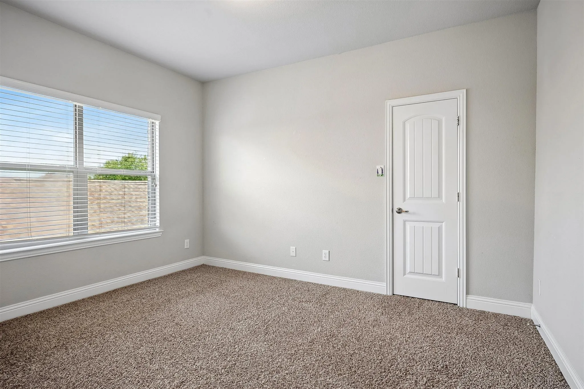 Neutral tone wall color with textured carpeting