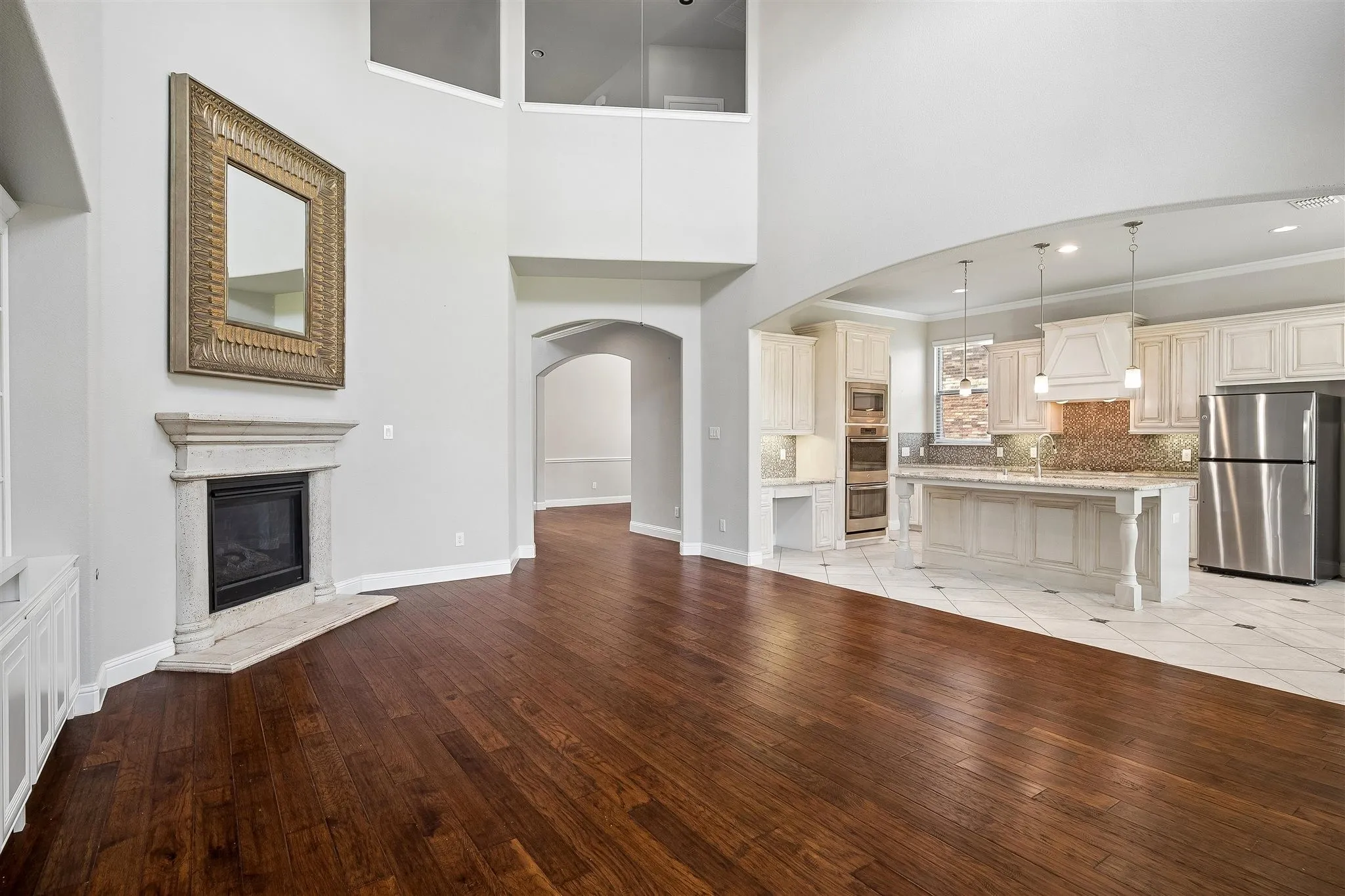 Vaulted ceilings create an expansive atmosphere, complemented by rich wood-finish flooring